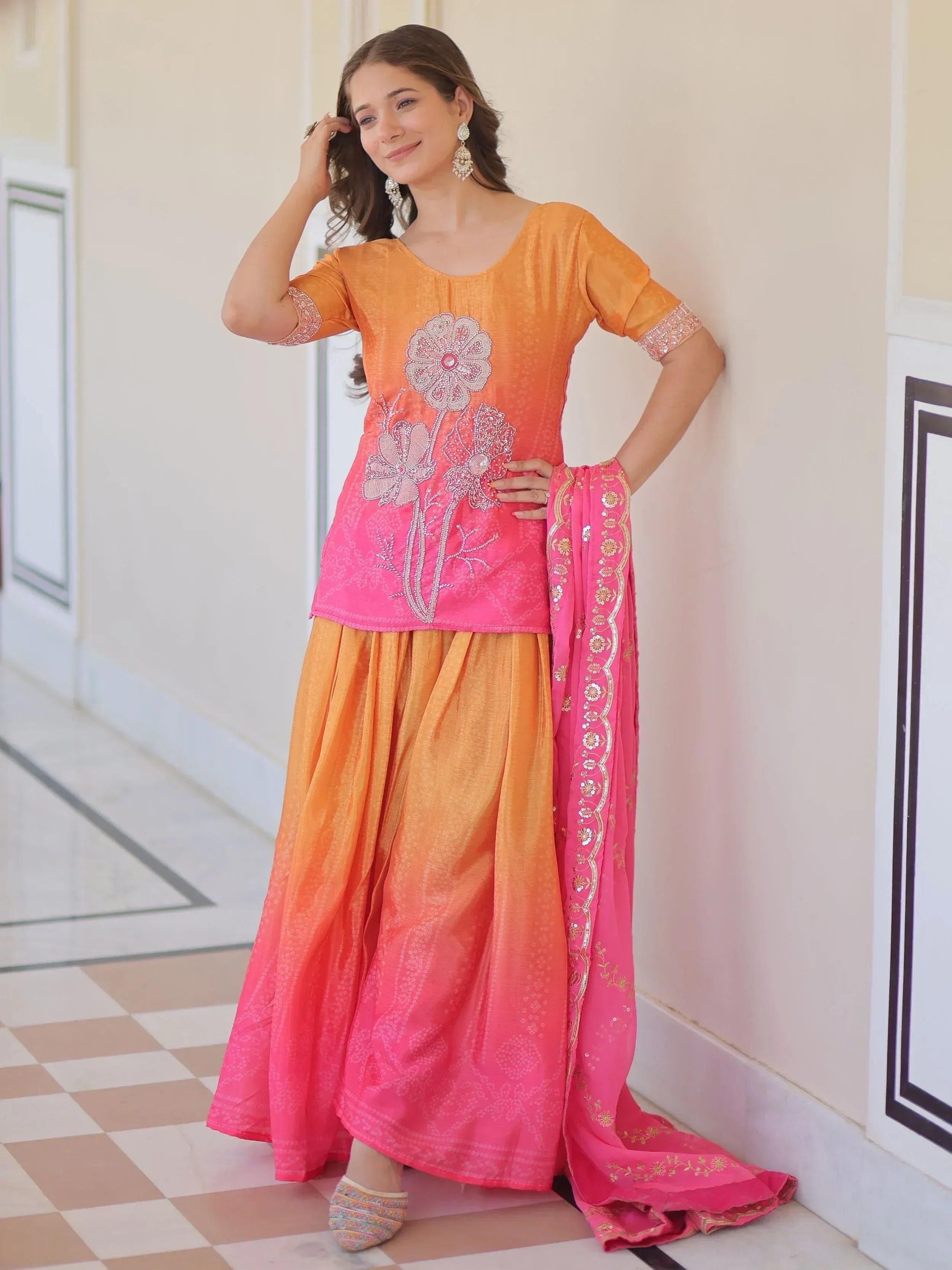 Orange and pink embroidered salwar kameez with floral design, perfect for Indian ethnic wear