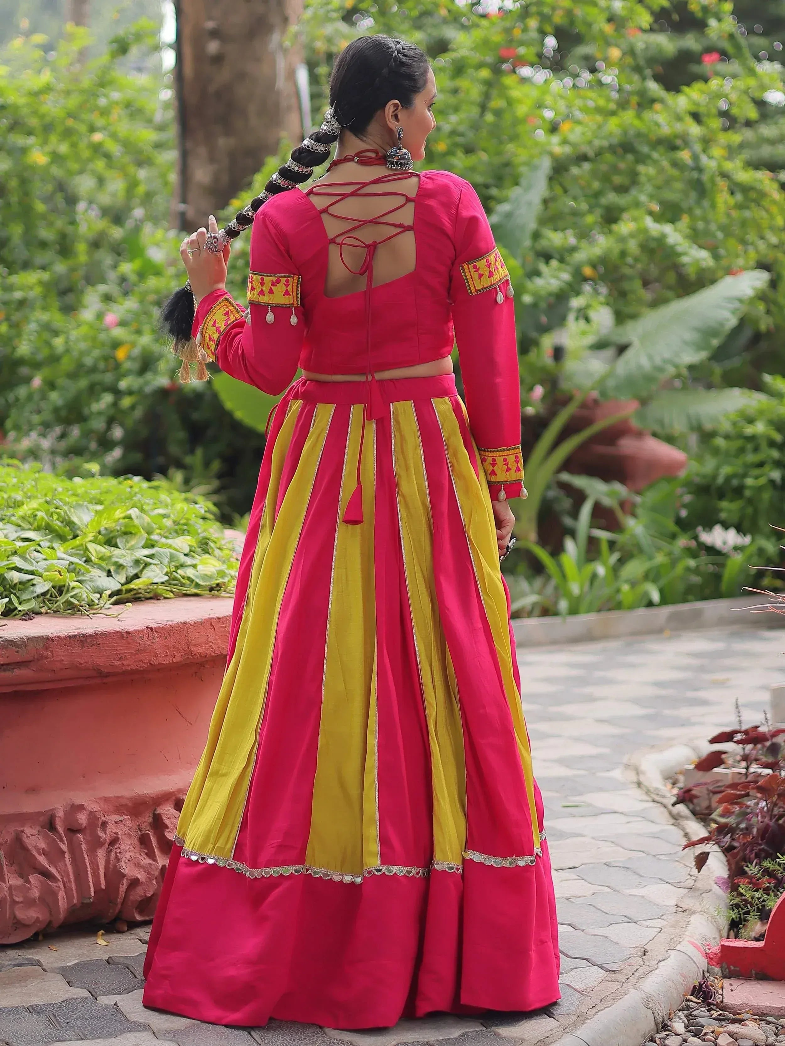 Vibrant pink and yellow ethnic lehenga with lace-up back and embroidered sleeves