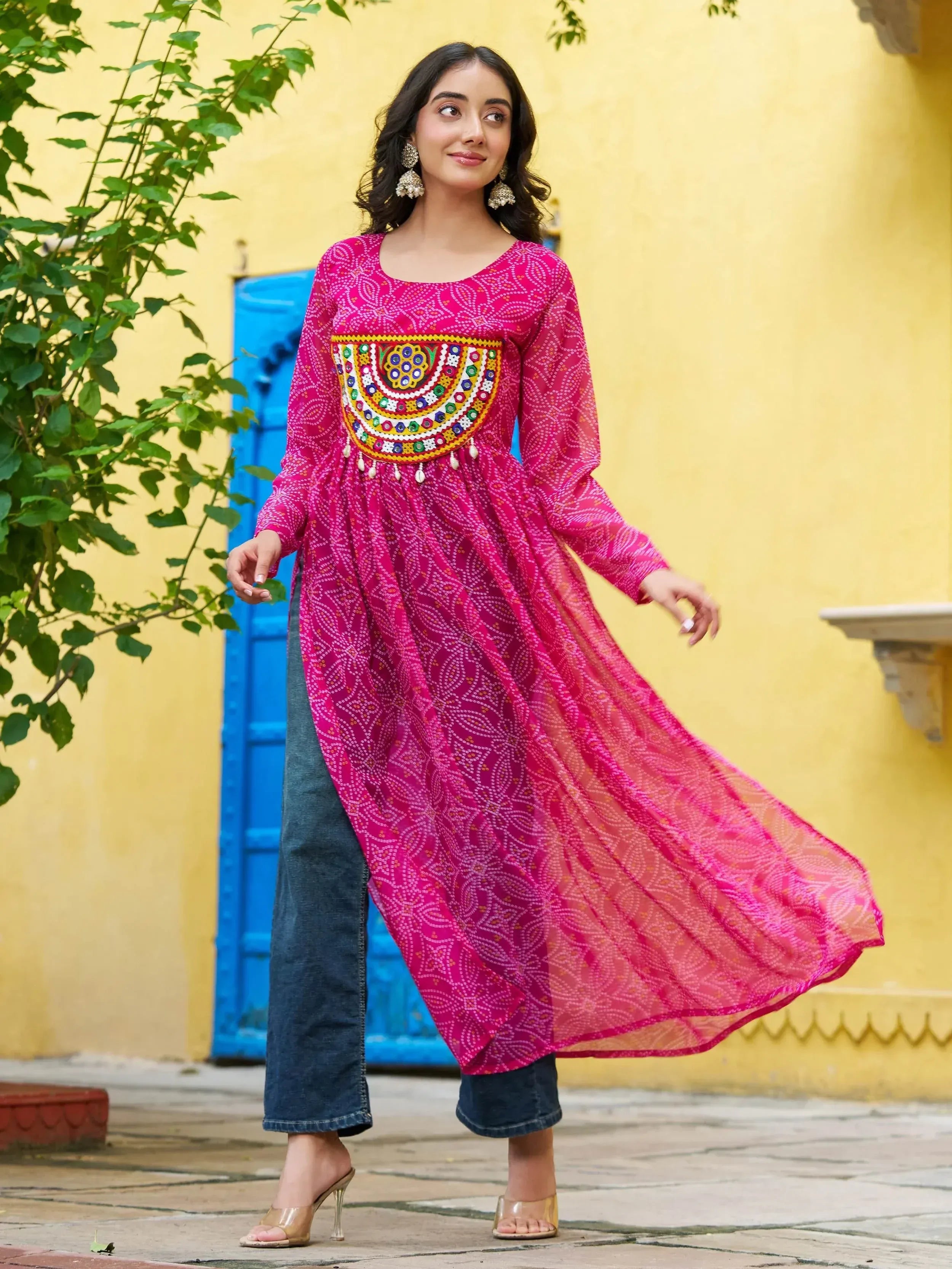 Pink embroidered ethnic kurta with mirror work, paired with jeans, perfect for Indian festive wear