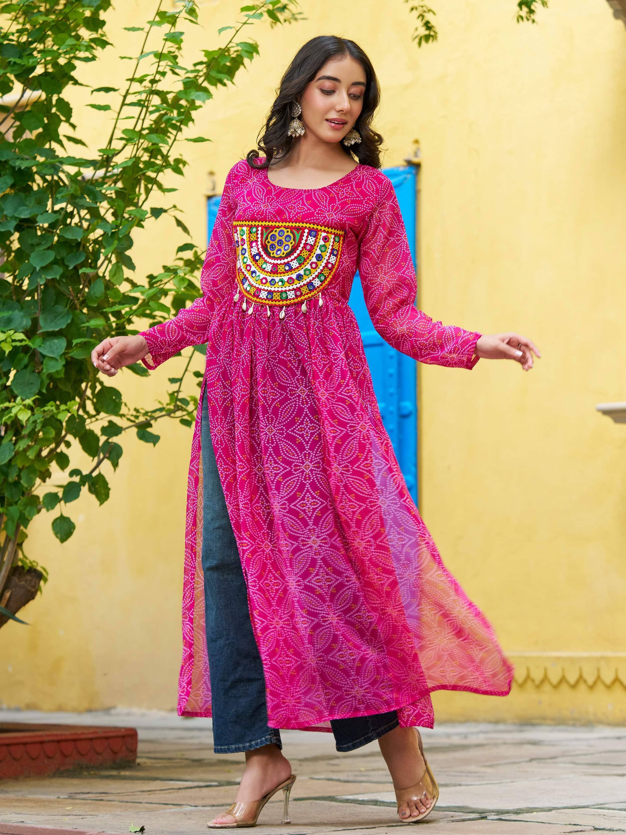 Pink ethnic kurta with mirror work and side slit, paired with jeans for casual Indian wear