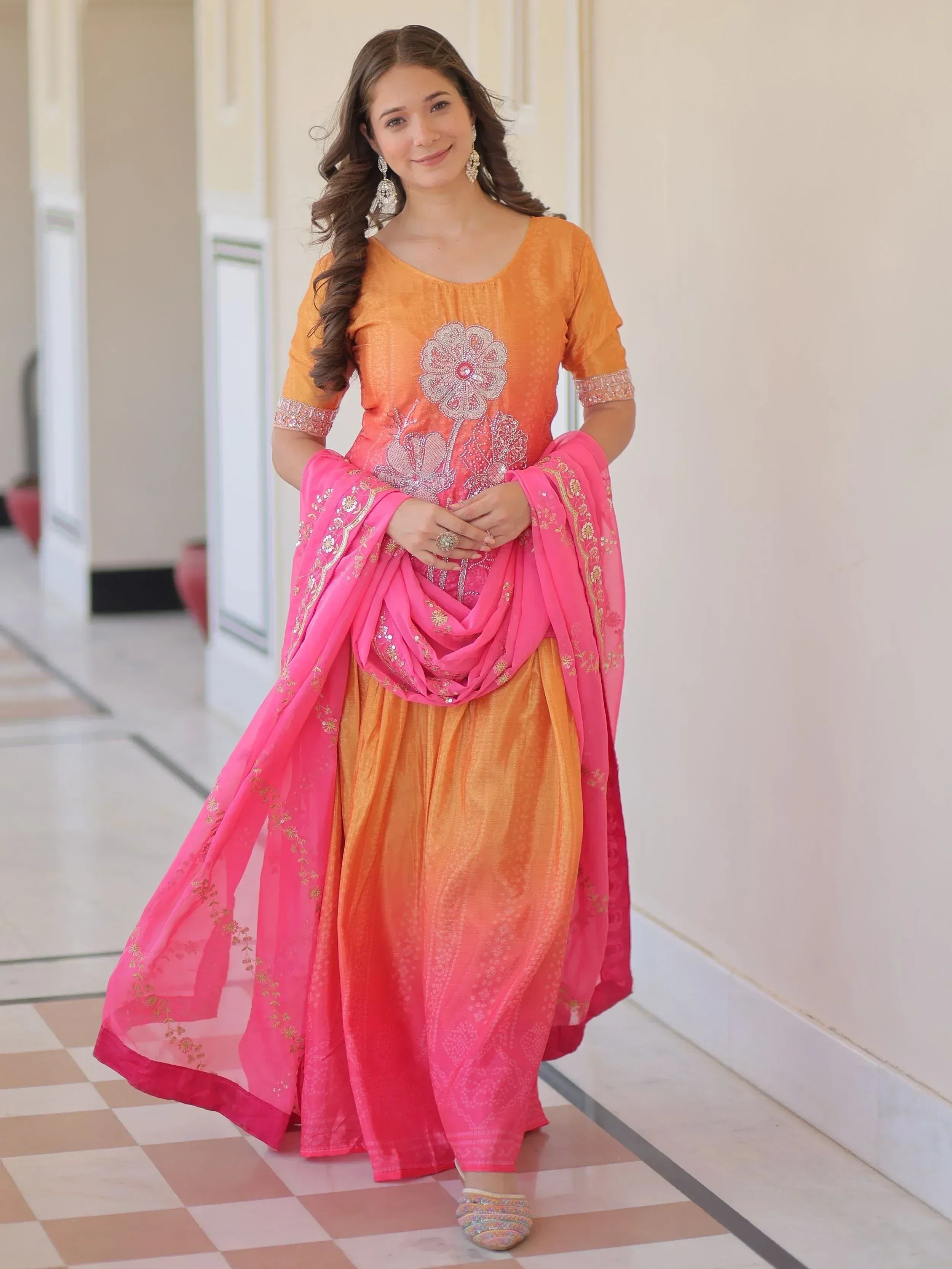 Orange and pink embroidered salwar kameez with floral design, perfect for Indian ethnic wear occasions