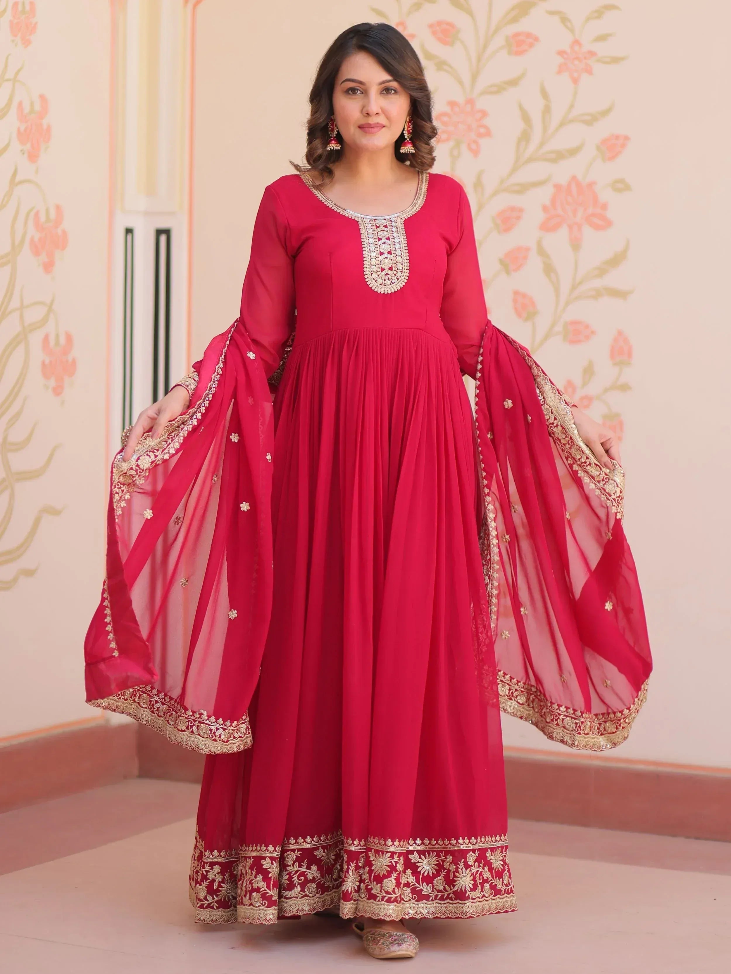 Red ethnic anarkali gown with gold embroidery and sheer sleeves, perfect for Indian occasions