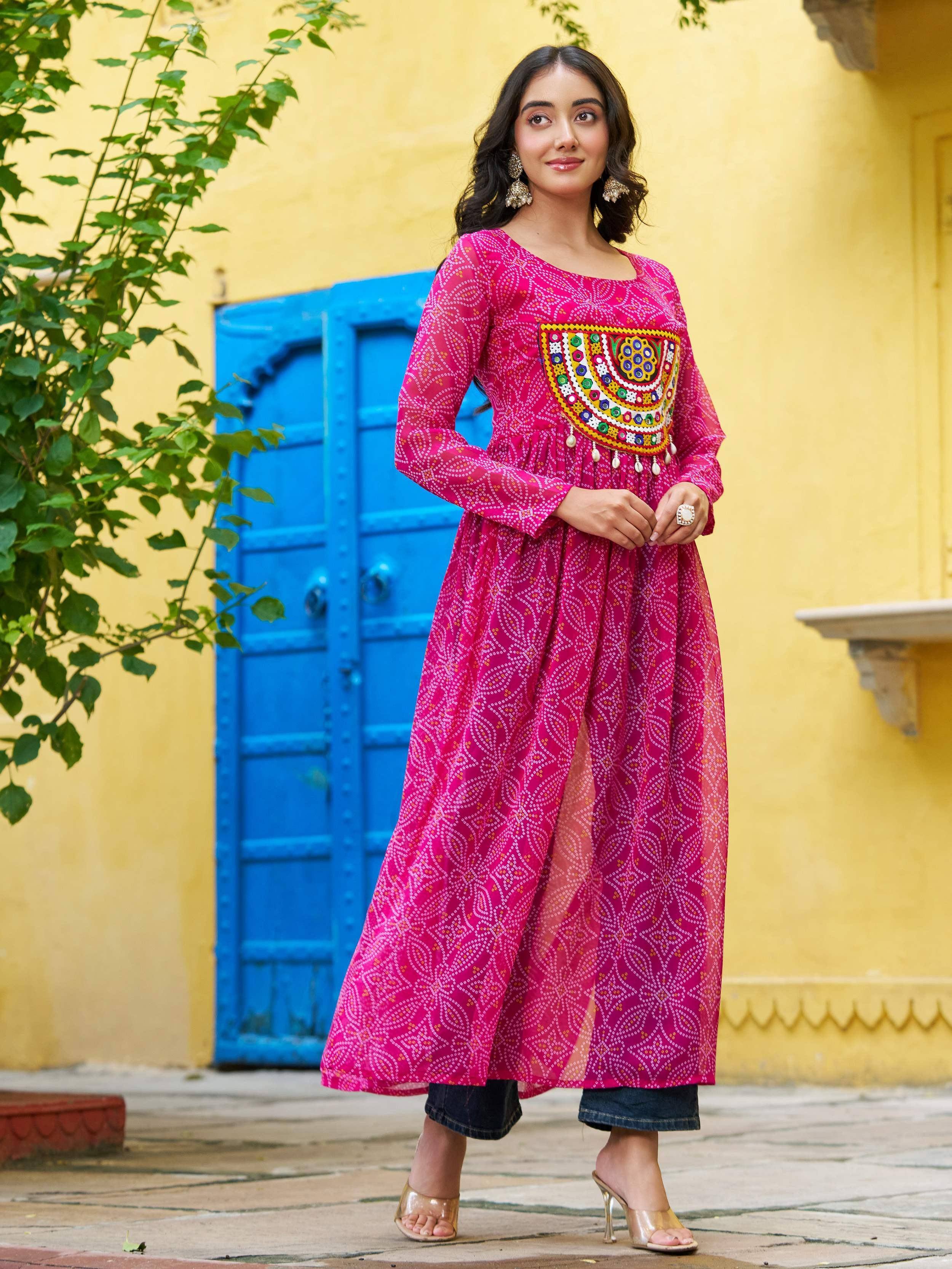 Pink ethnic kurti with mirror work and side slit, paired with jeans, perfect for Indian festive wear
