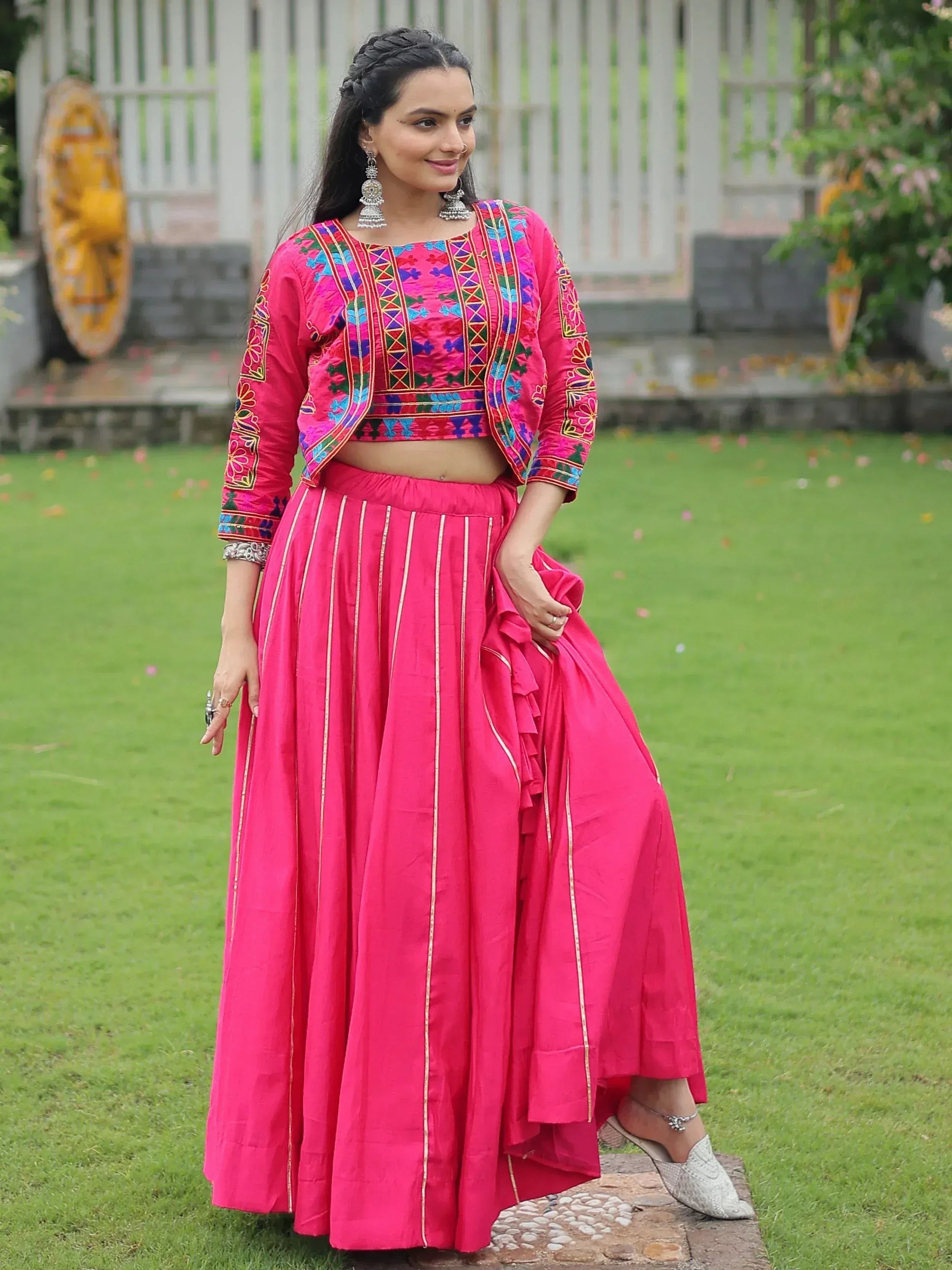 Vibrant pink embroidered lehenga choli with colorful mirror work, perfect for Indian ethnic occasions