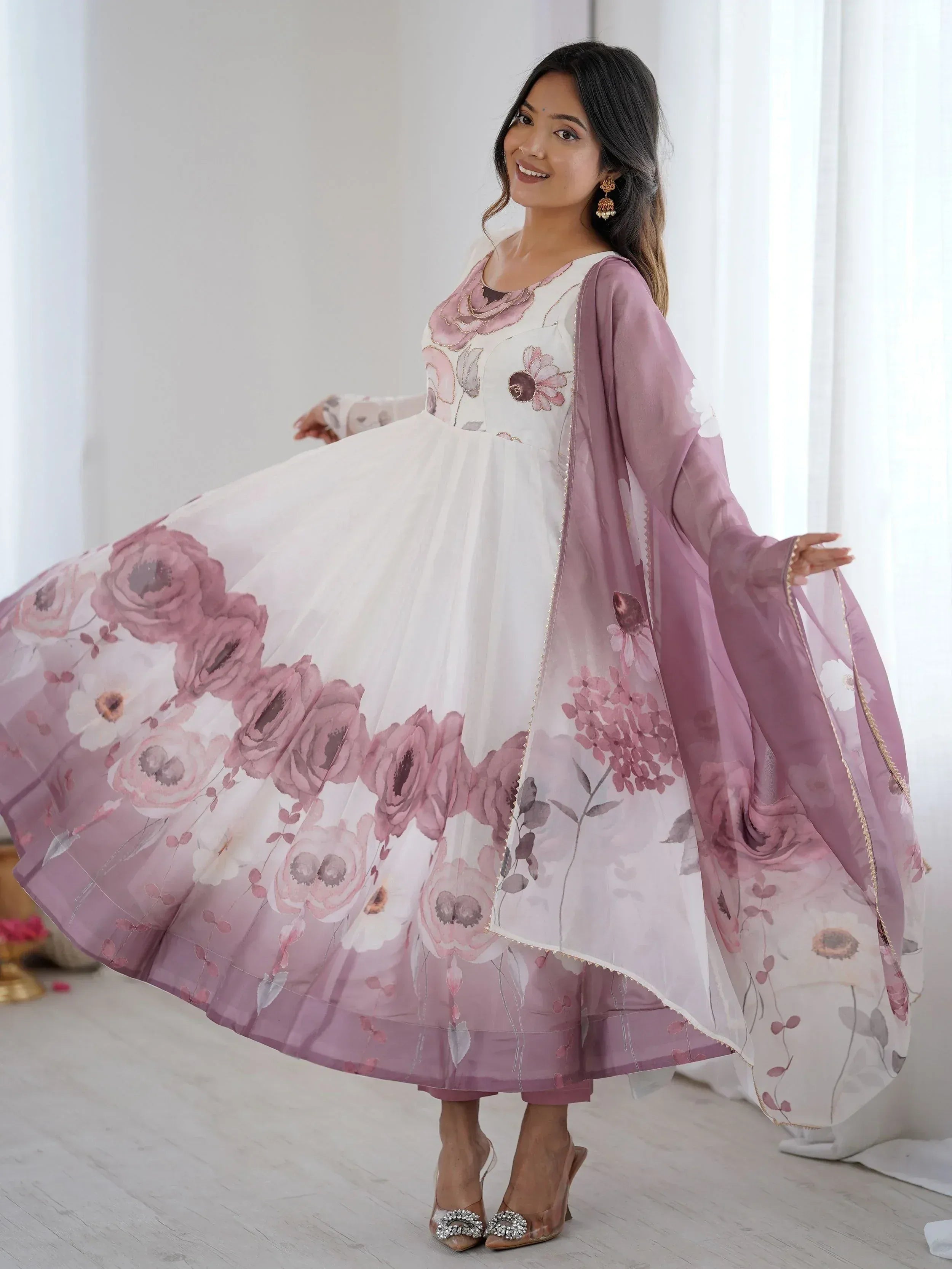 Woman in white and pink floral printed Anarkali gown with dupatta, ethnic Indian wear