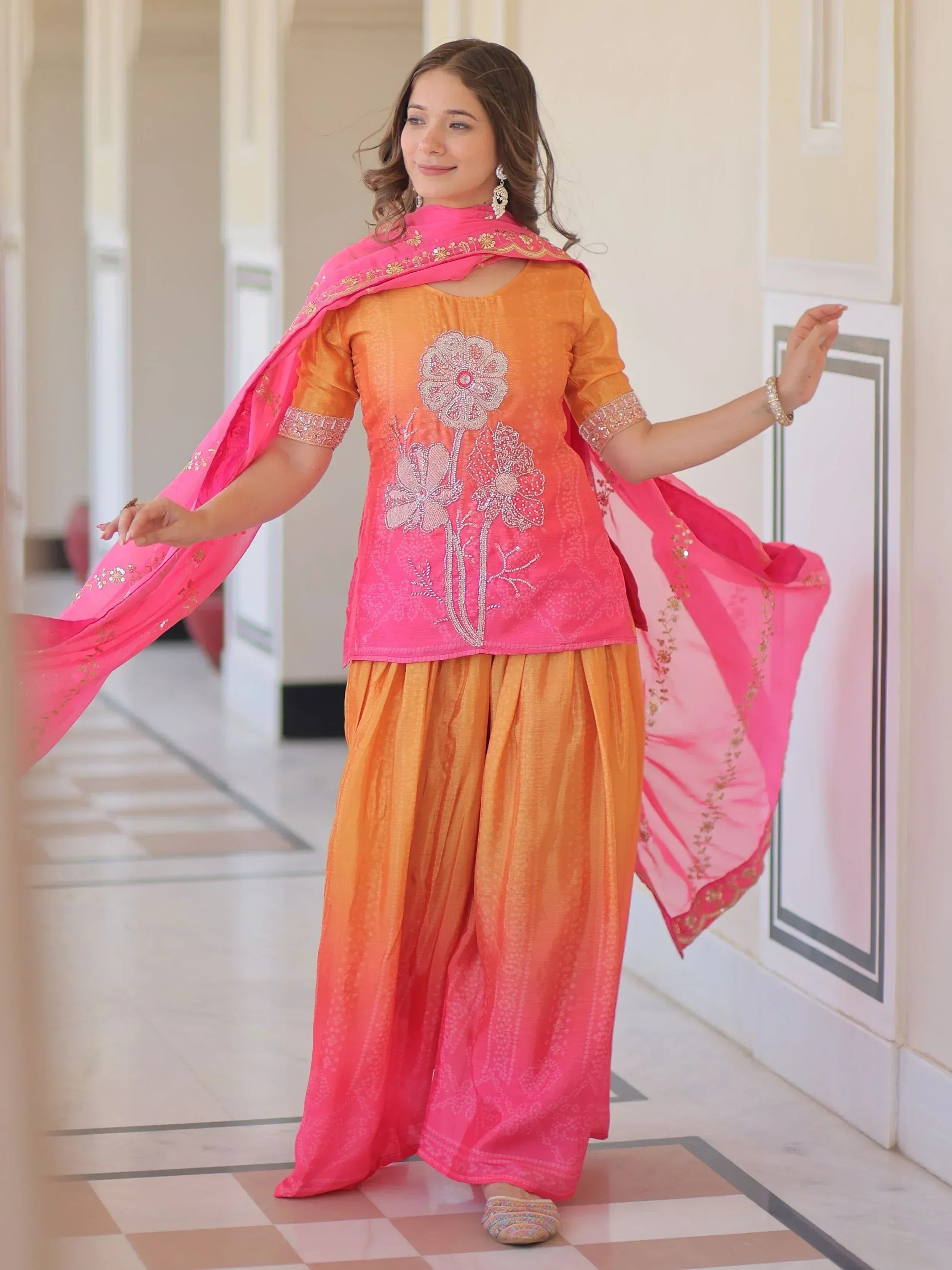 Orange and pink embroidered salwar kameez with floral design and matching dupatta, ideal for Indian ethnic wear