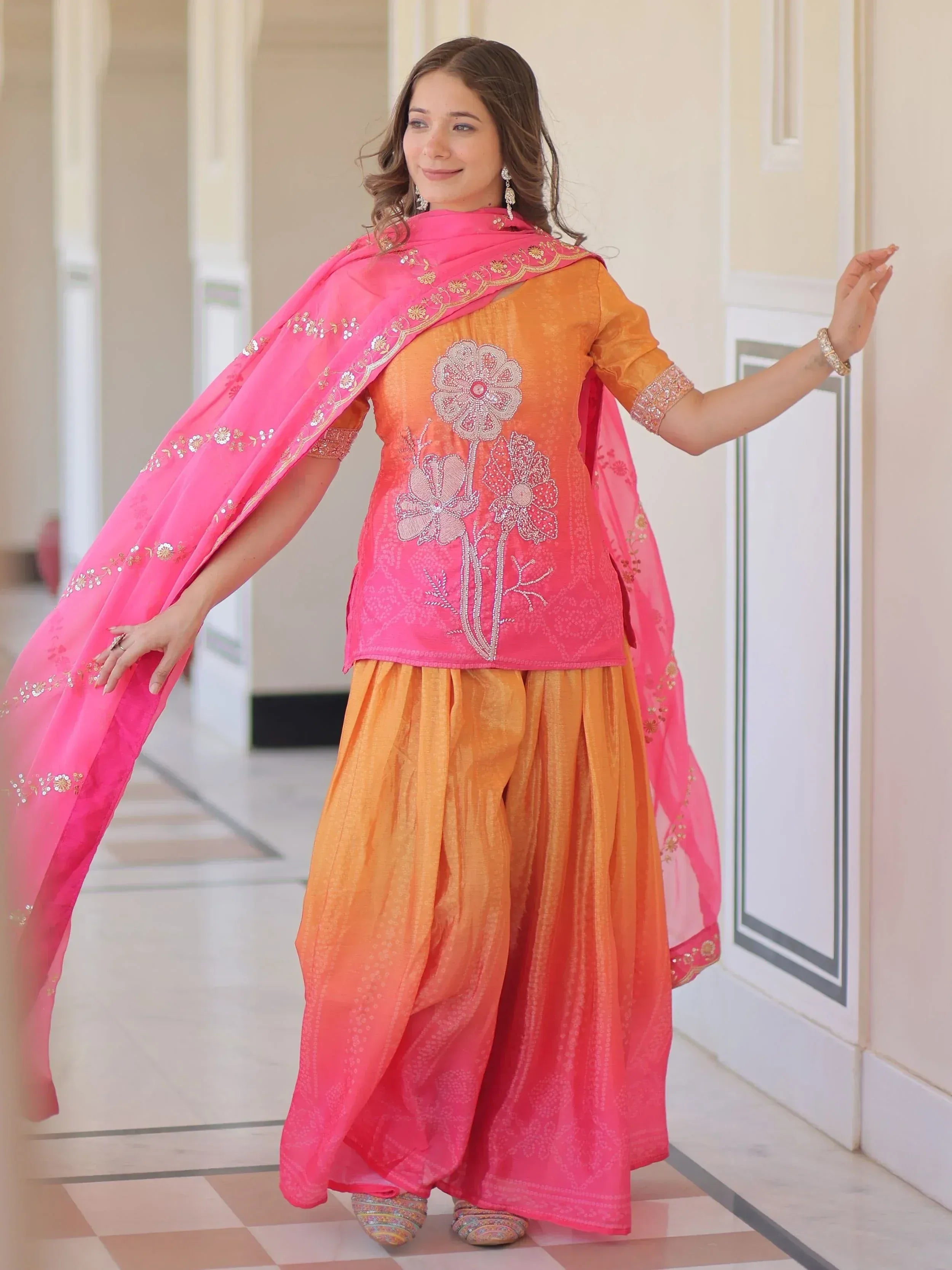 Orange and pink embroidered salwar kameez with floral design and matching dupatta, ideal for Indian ethnic wear