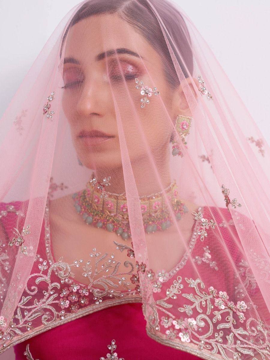 Pink embroidered lehenga choli with floral veil and jewelry, Indian ethnic wear
