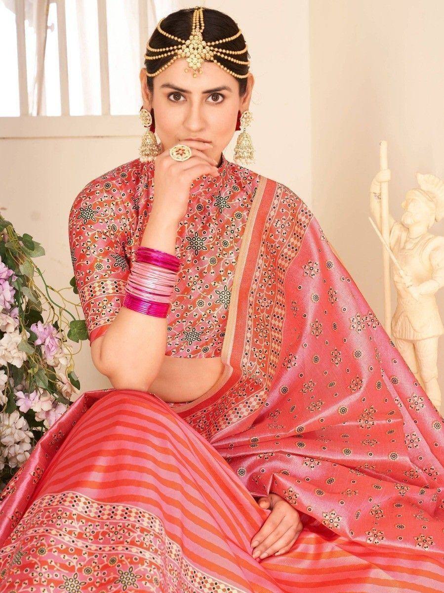 Woman in pink printed lehenga choli with gold jewelry, traditional Indian ethnic wear