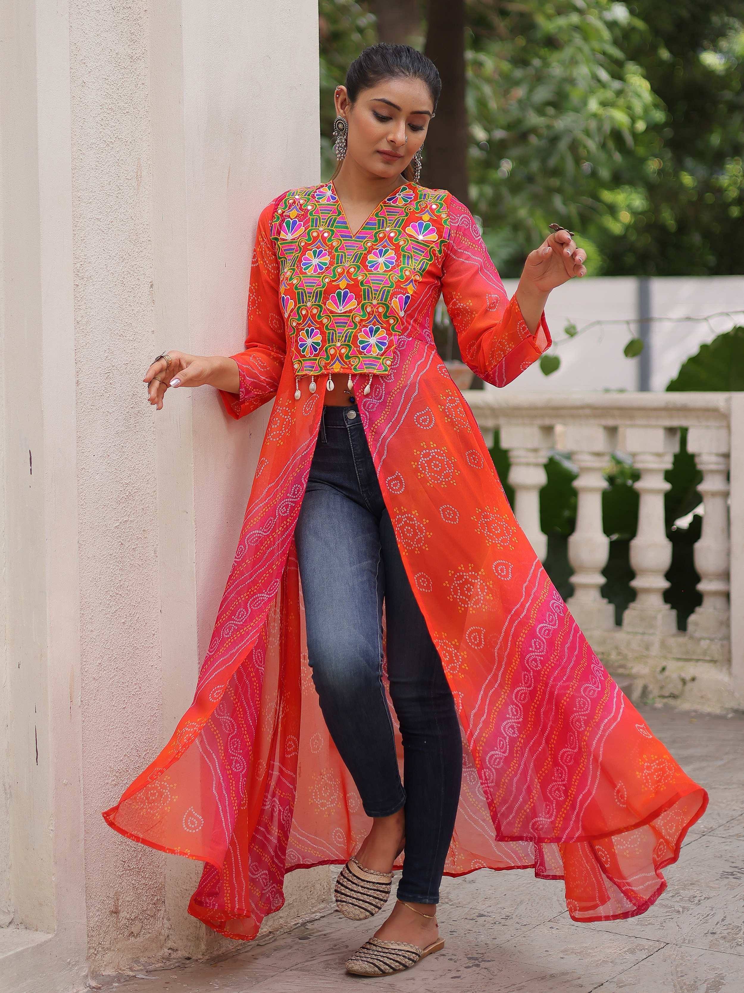 Vibrant orange ethnic long jacket with colorful embroidery, paired with jeans for fusion style