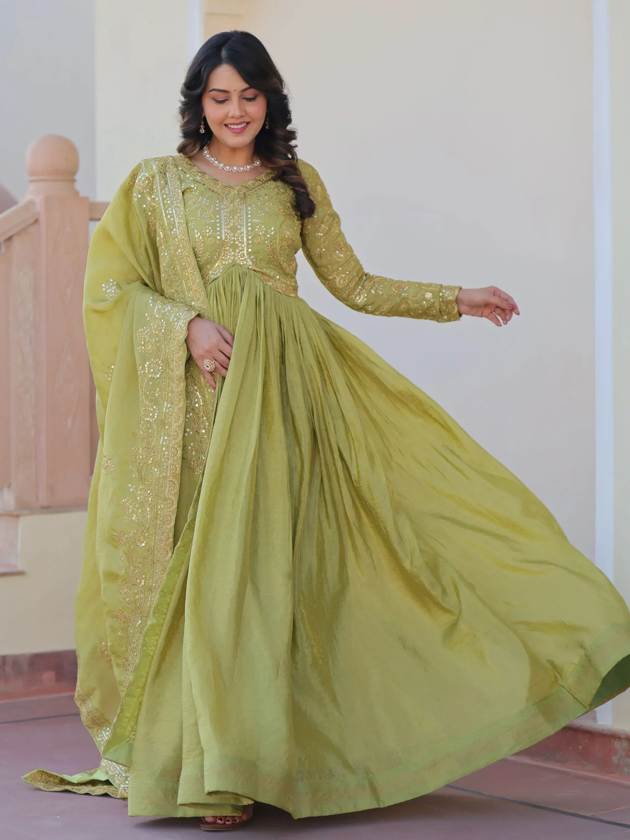 Elegant olive green ethnic gown with gold embroidery and sequins, perfect for Indian occasions