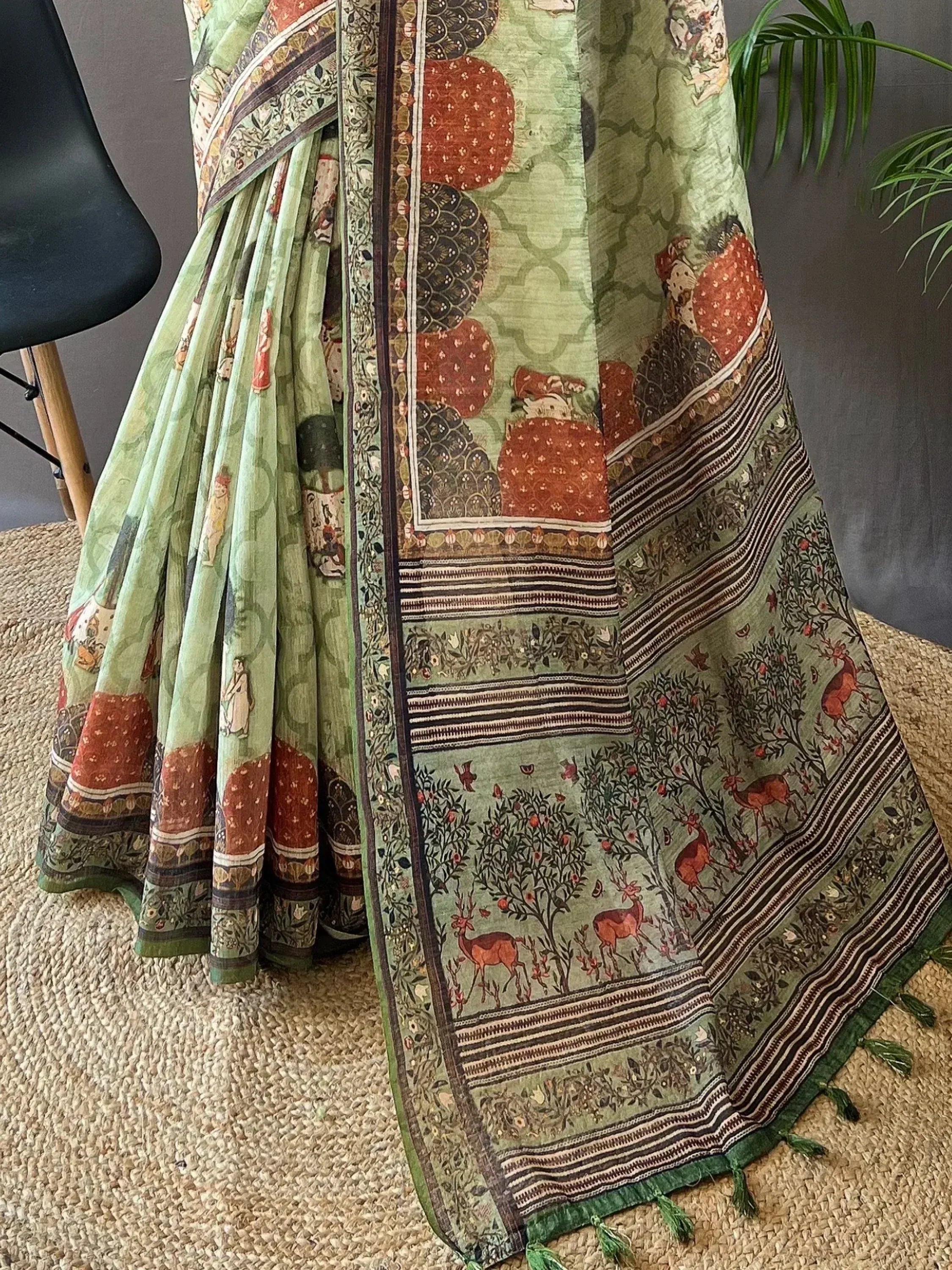 Green printed saree with deer and floral motifs, ethnic Indian wear