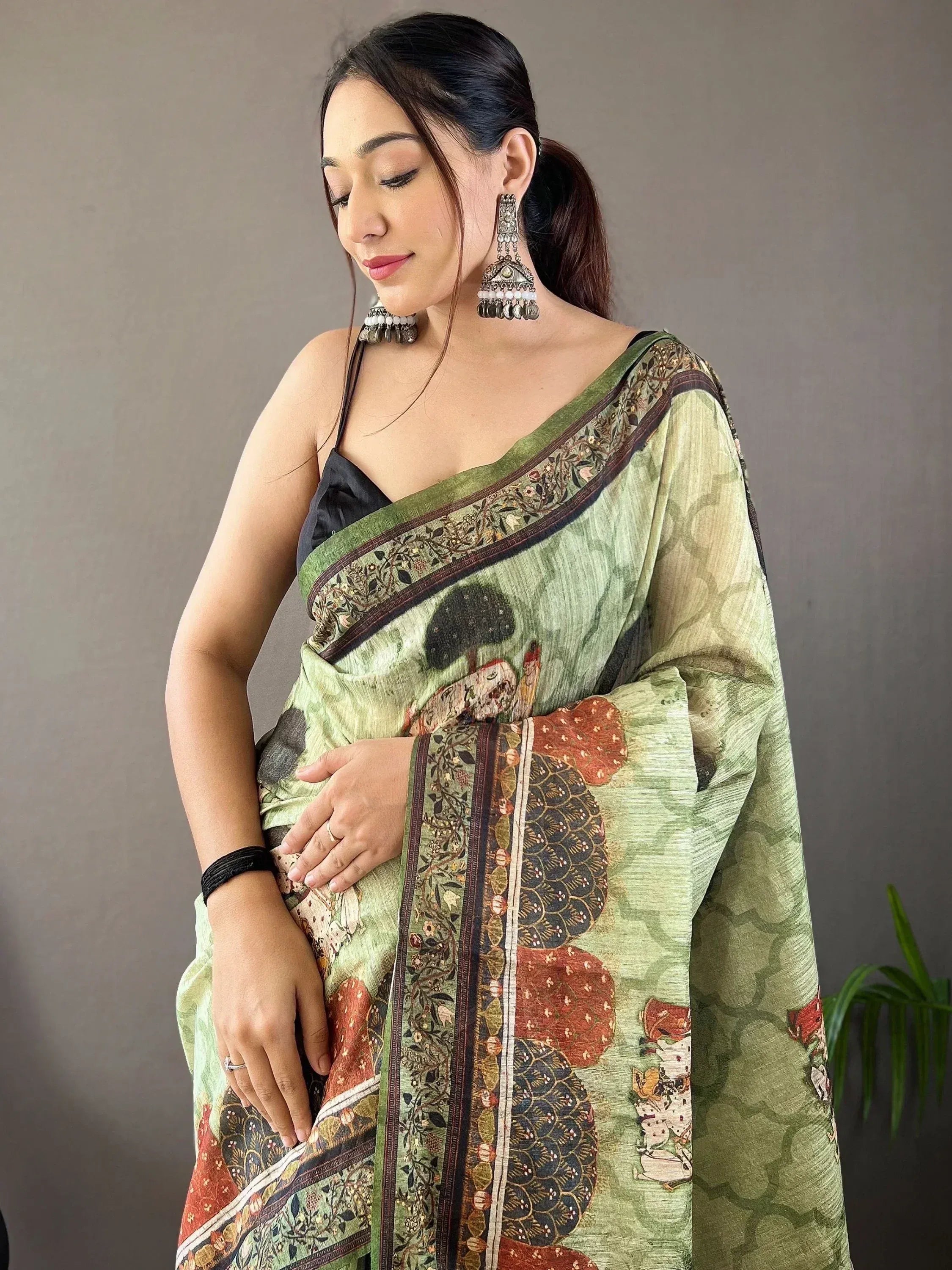 Woman in green printed saree with floral border, ethnic wear, designer Indian saree