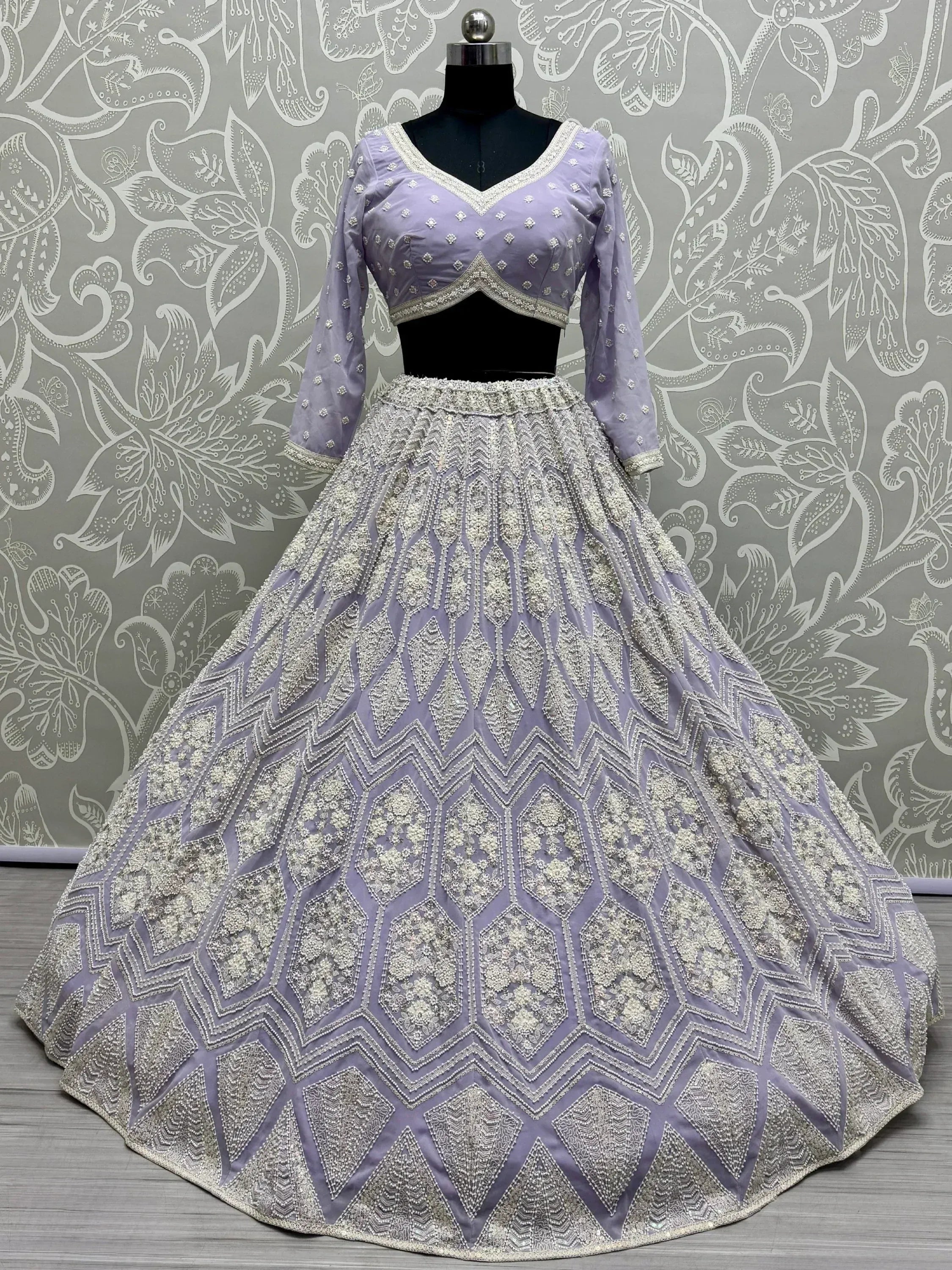 Lavender designer lehenga choli with heavy silver embroidery and geometric patterns, perfect for Indian ethnic wear.