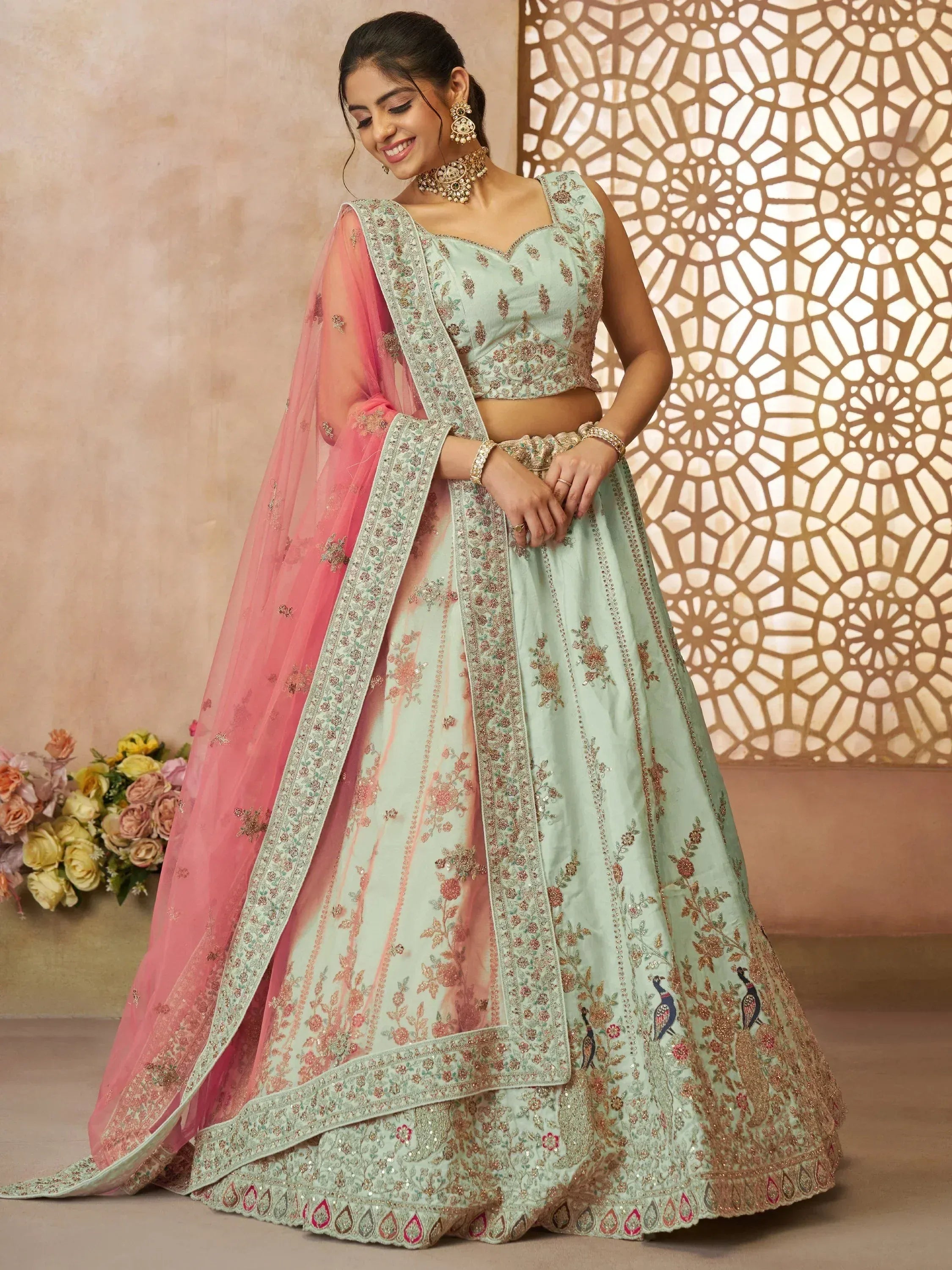 Mint green embroidered lehenga choli with pink dupatta, perfect for Indian weddings and festive occasions.