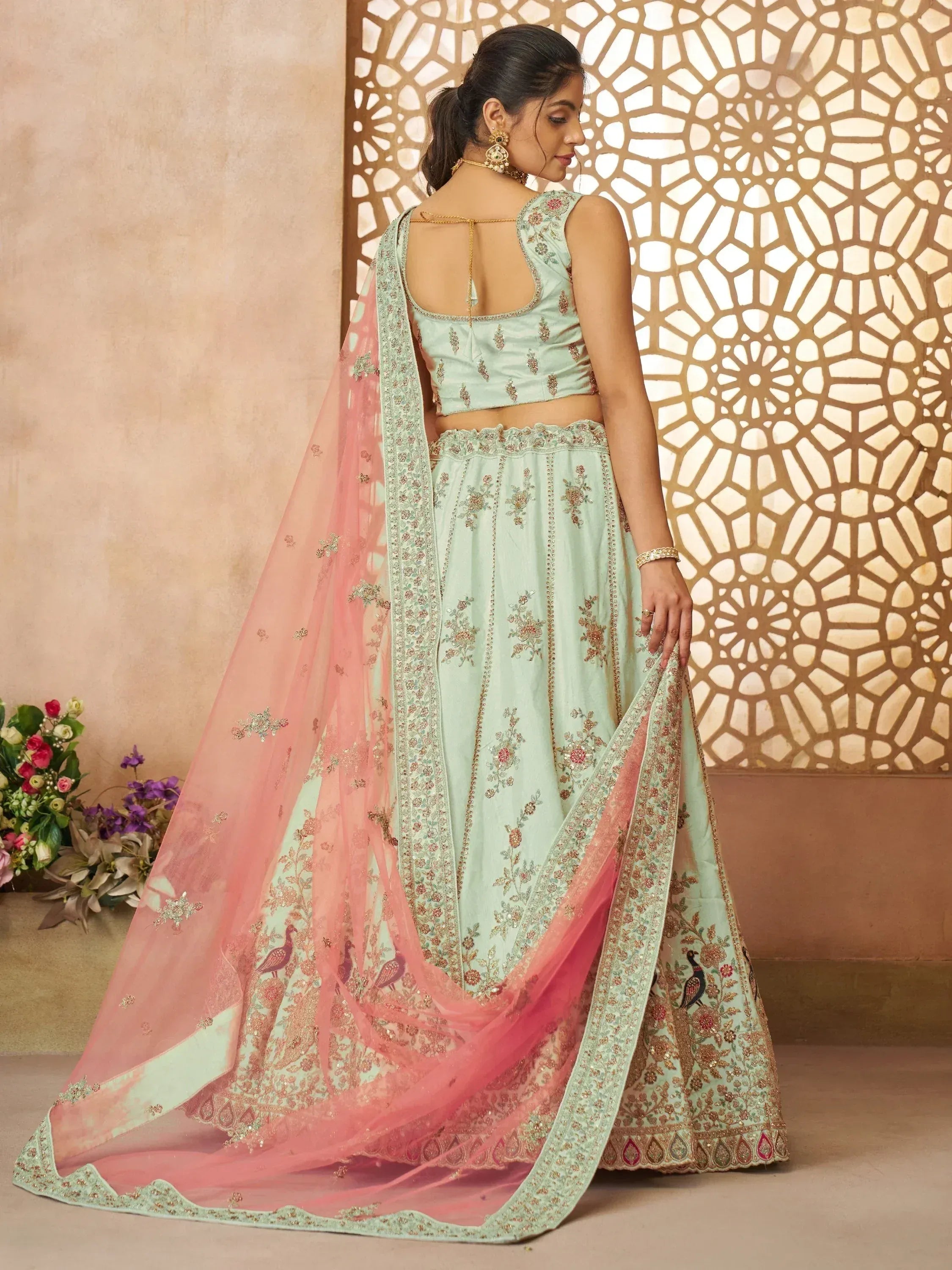 Mint green embroidered lehenga choli with pink dupatta, floral and peacock motifs, back view