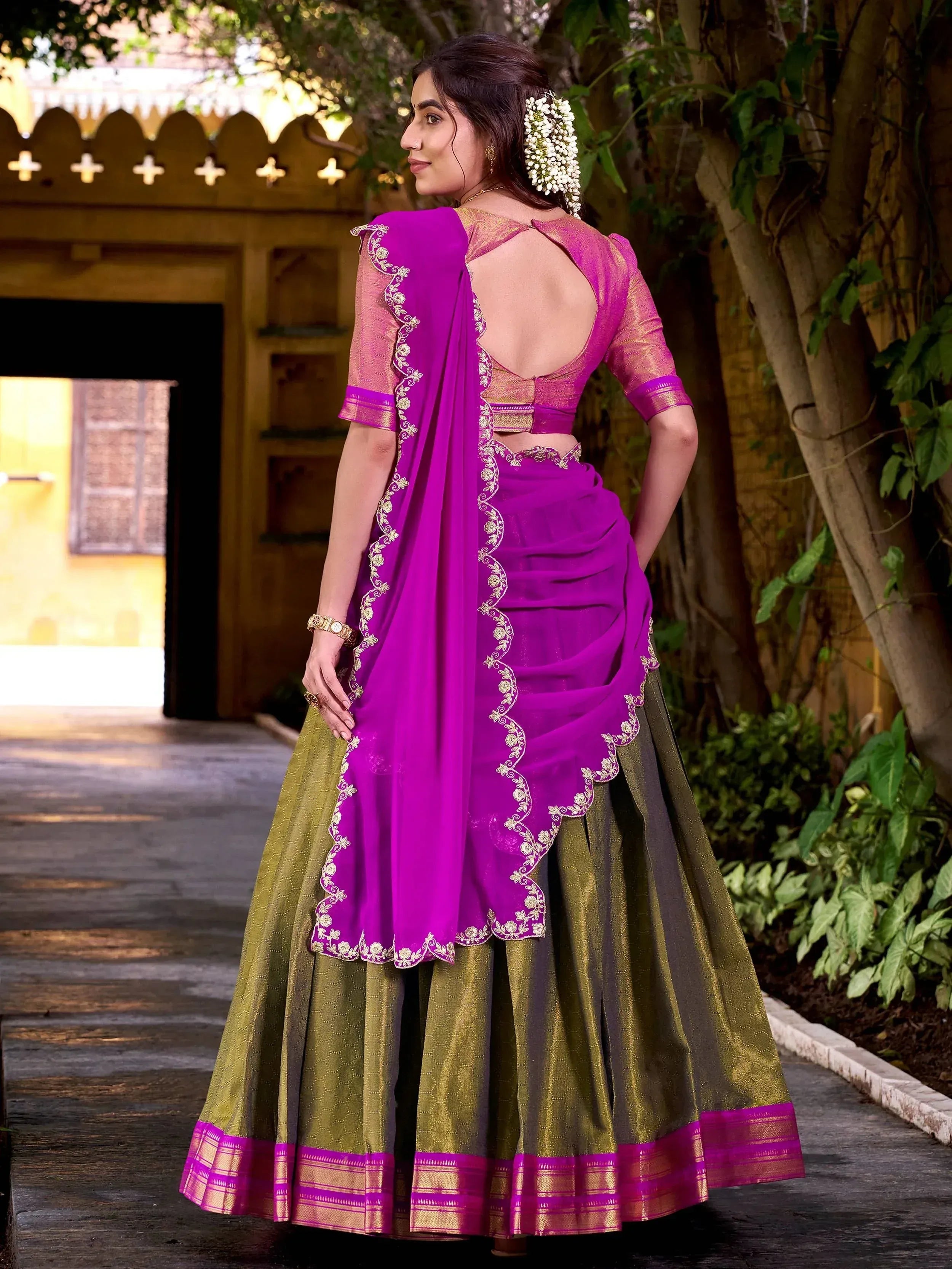 Vibrant purple and green designer lehenga choli with gold embroidery, perfect for Indian ethnic wear.