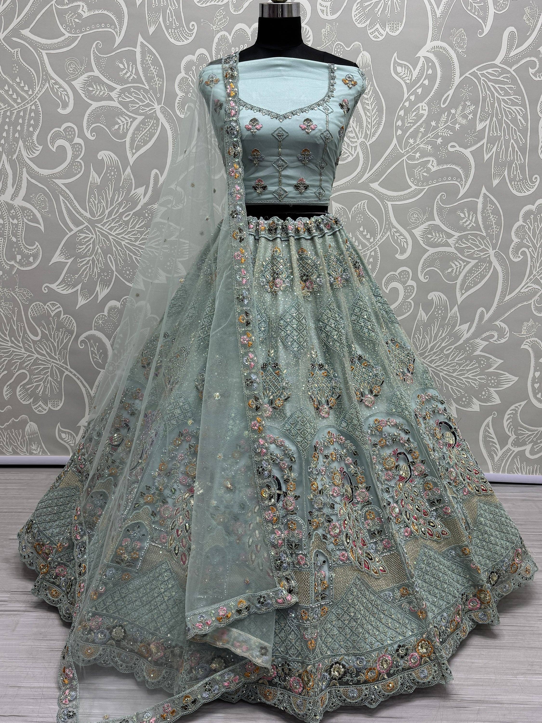 Light blue designer lehenga choli with floral embroidery and net dupatta, perfect for Indian weddings and festive occasions.