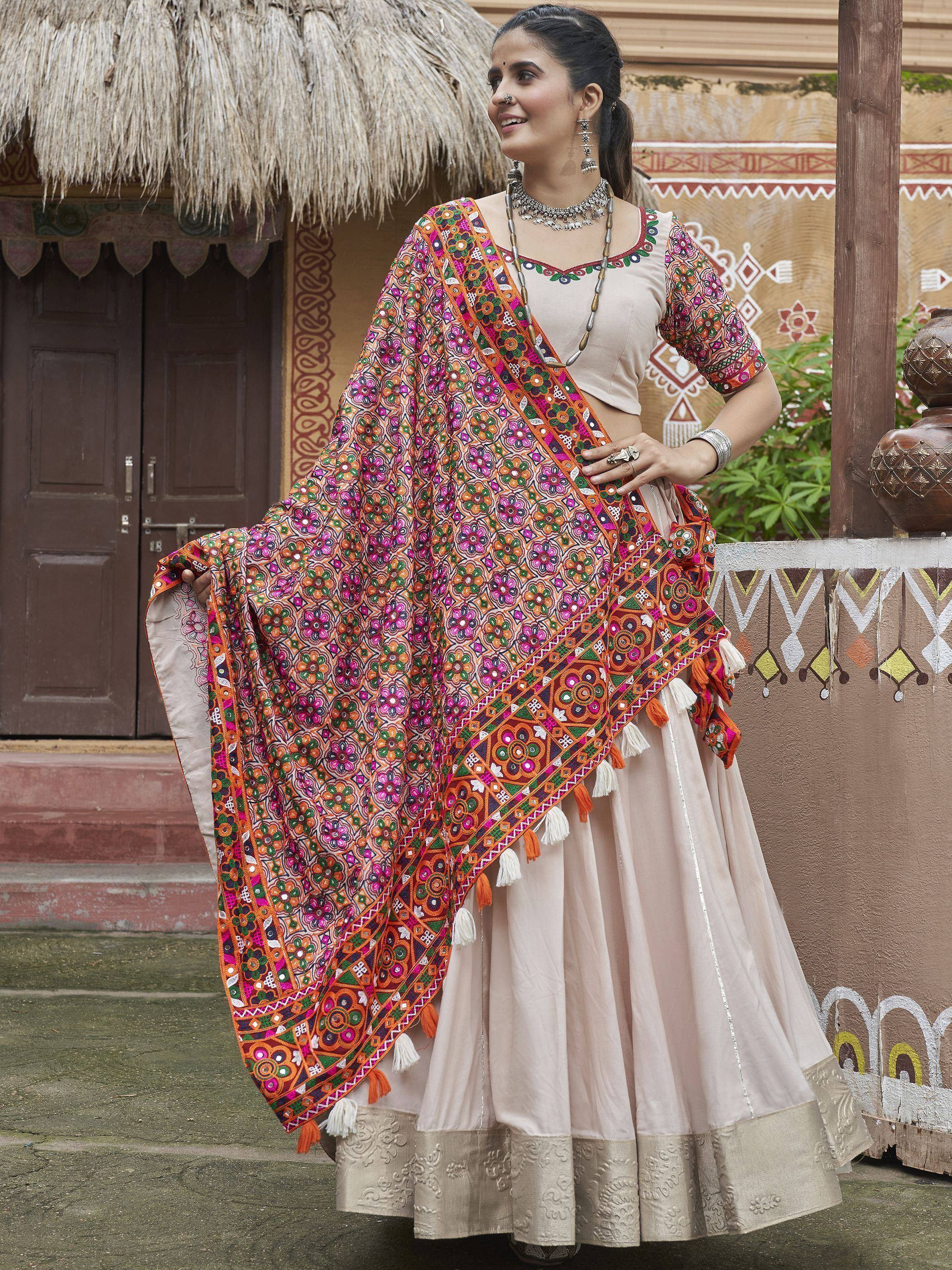 Woman in ethnic lehenga choli with colorful embroidered dupatta, traditional Indian wear