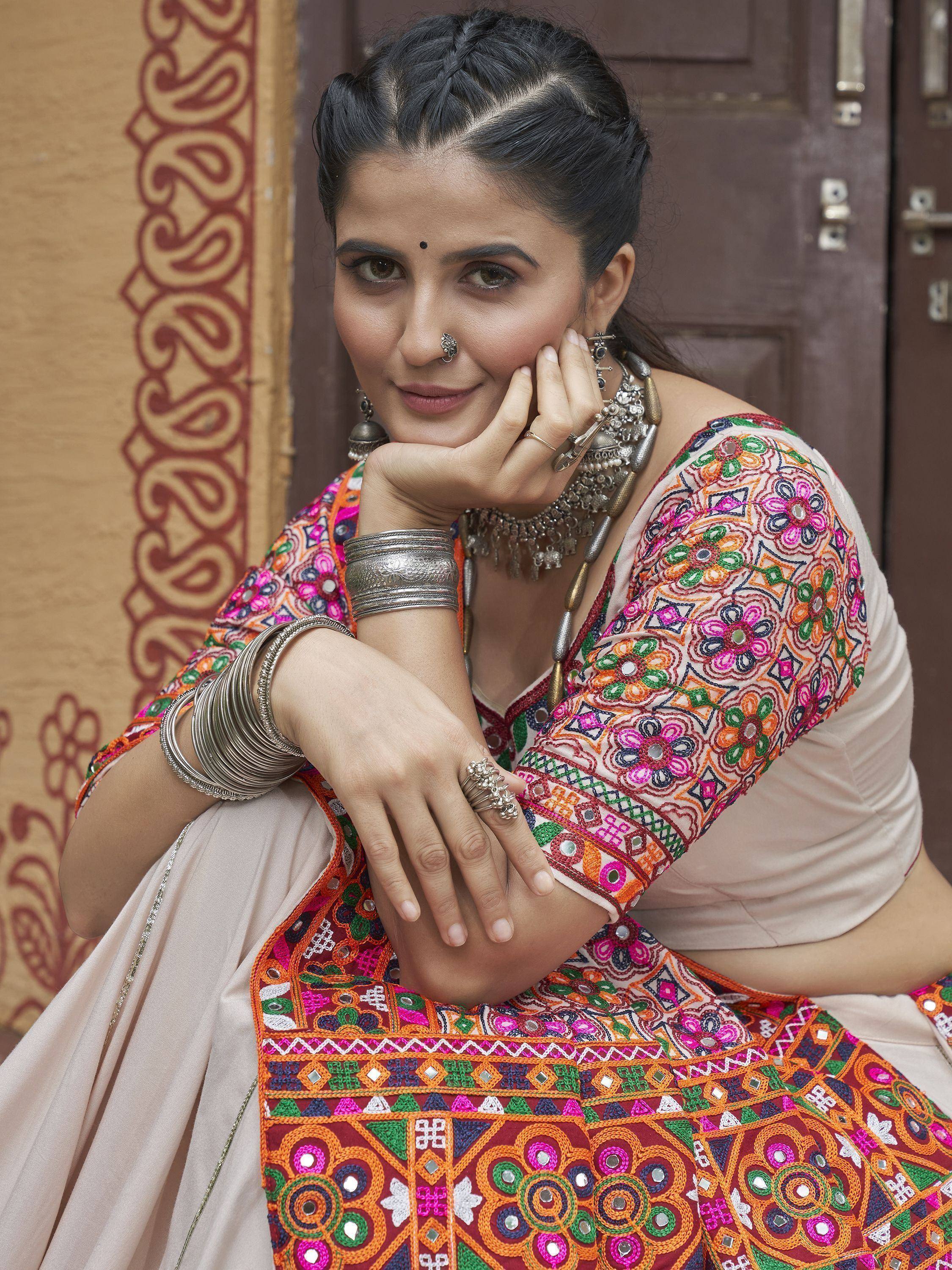 Woman in colorful embroidered Indian ethnic wear with mirror work and traditional jewelry
