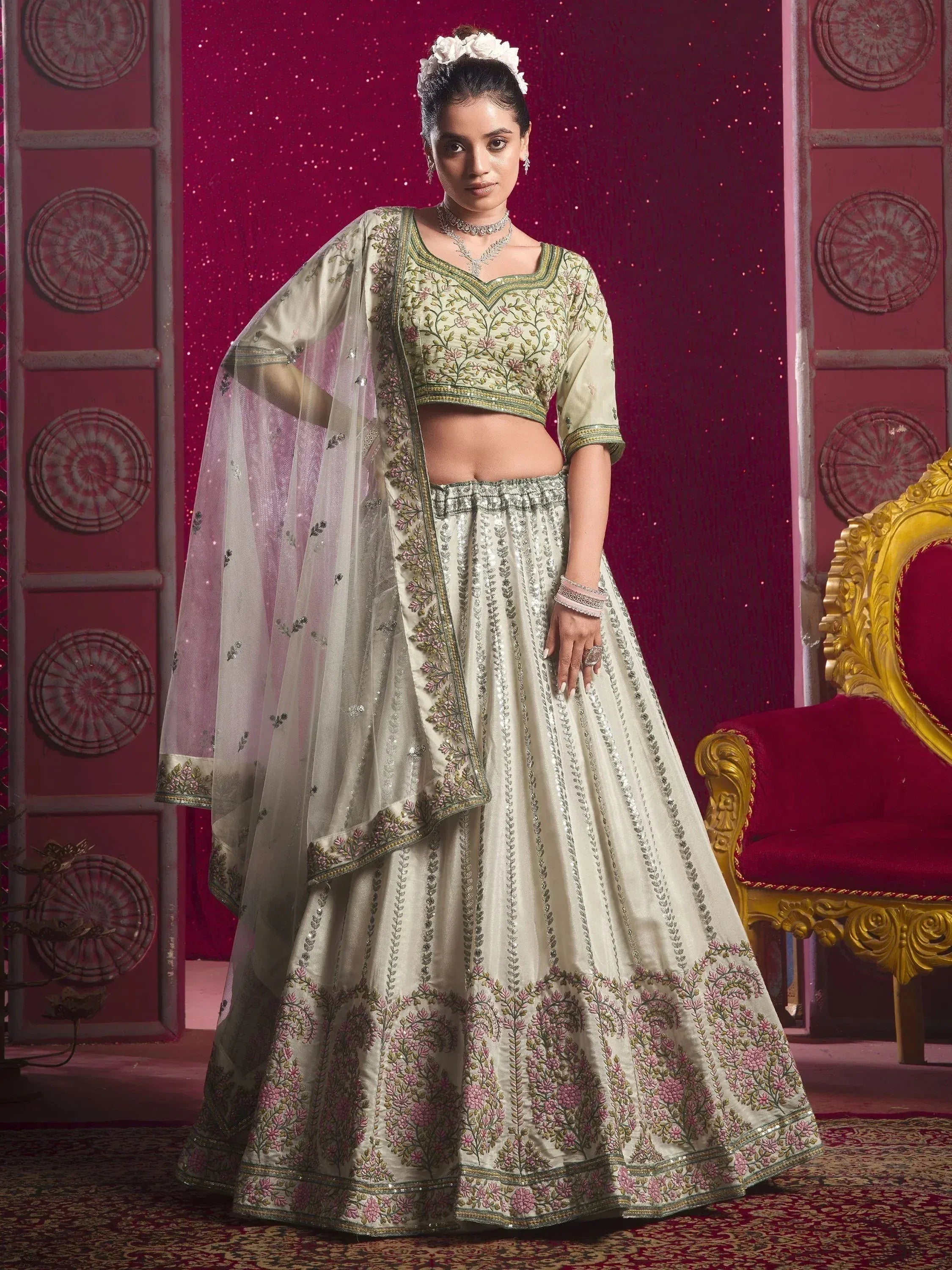 Elegant ivory lehenga choli with floral embroidery and sheer dupatta, perfect for Indian weddings and festive occasions.