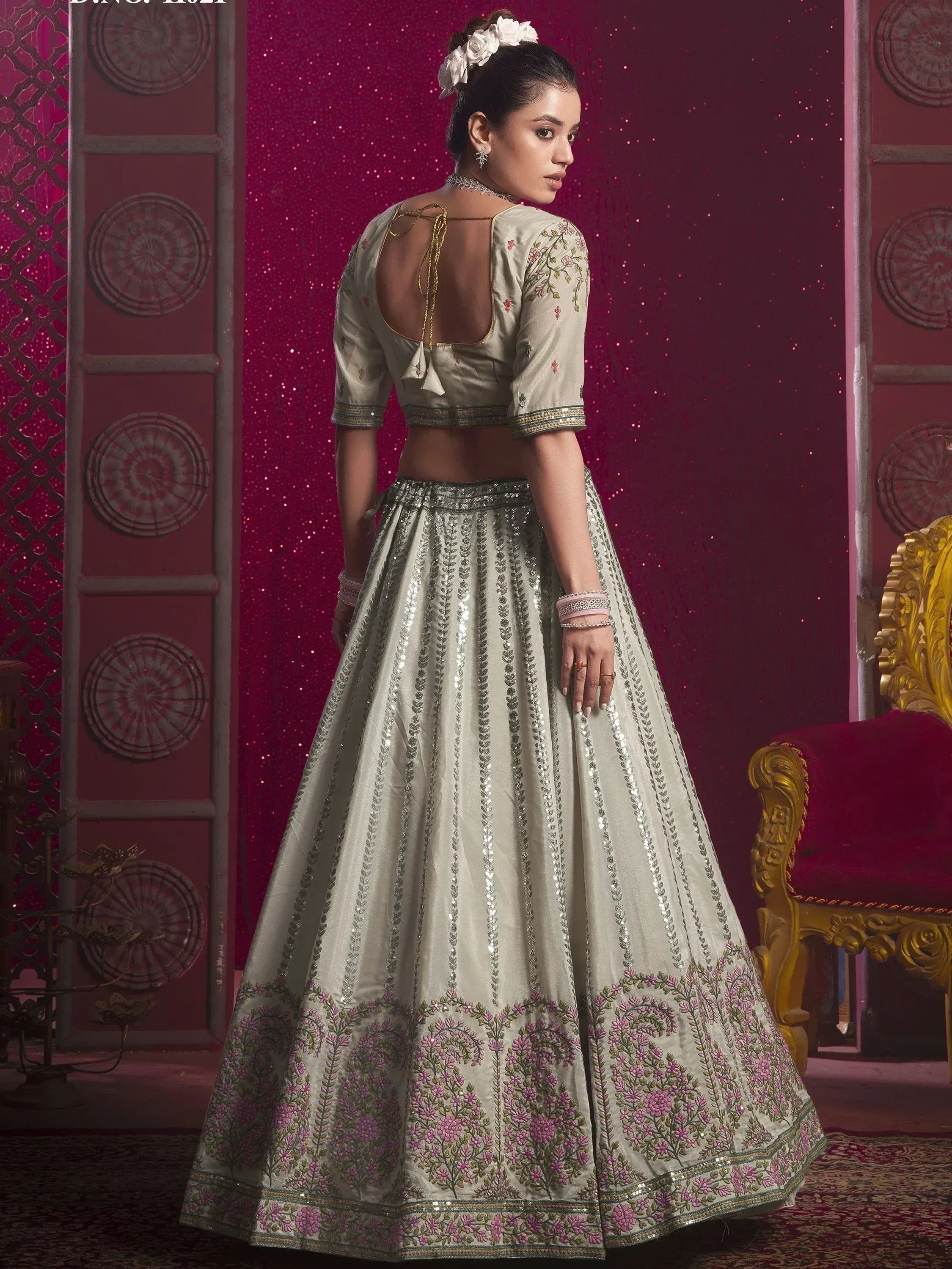 Elegant ivory lehenga choli with floral embroidery and sequin detailing, perfect for Indian weddings and festive occasions.