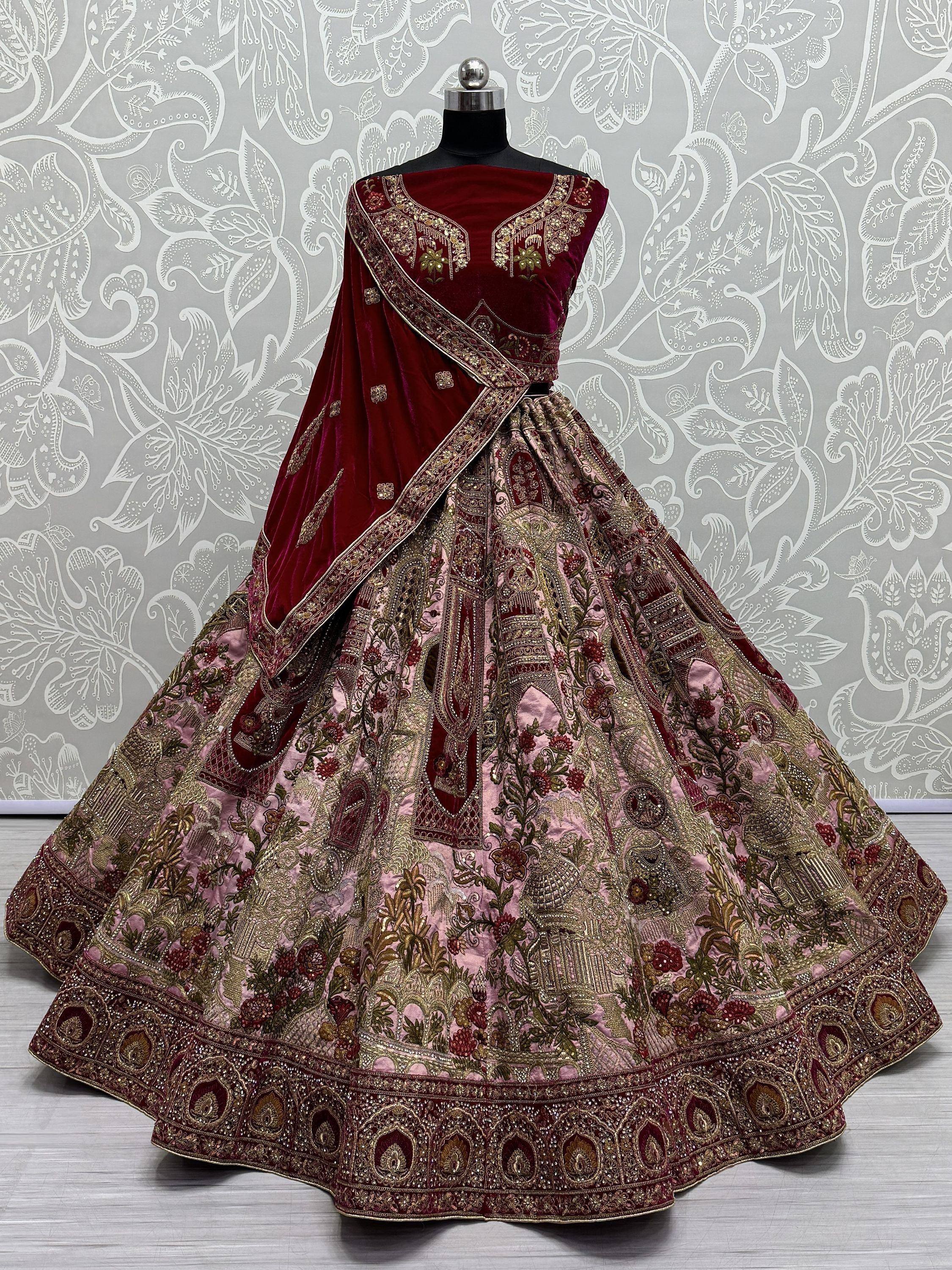 Maroon velvet designer lehenga choli with heavy gold embroidery and floral motifs, perfect for Indian weddings