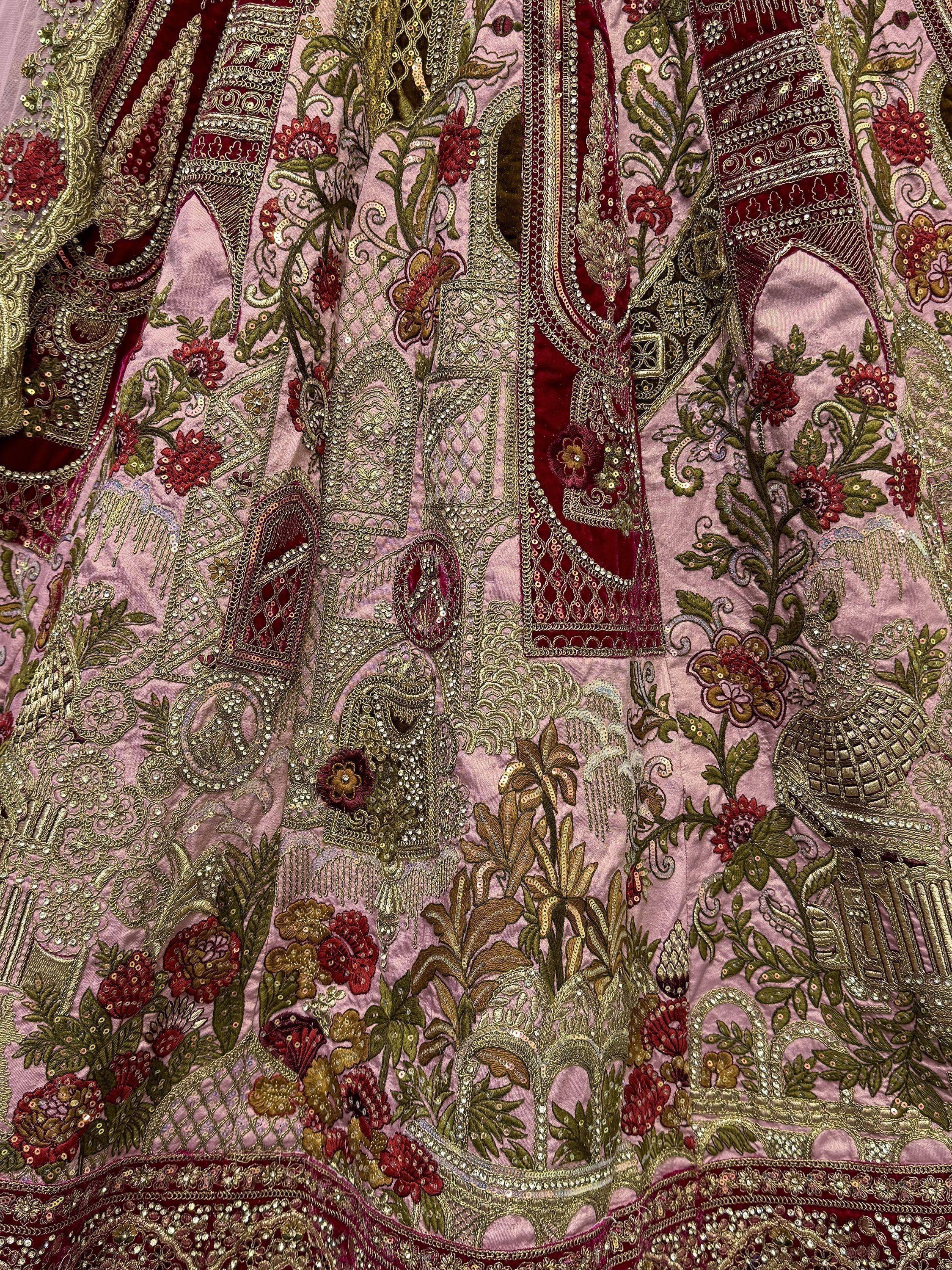 Pink and maroon ethnic gown with intricate floral embroidery and gold sequin detailing