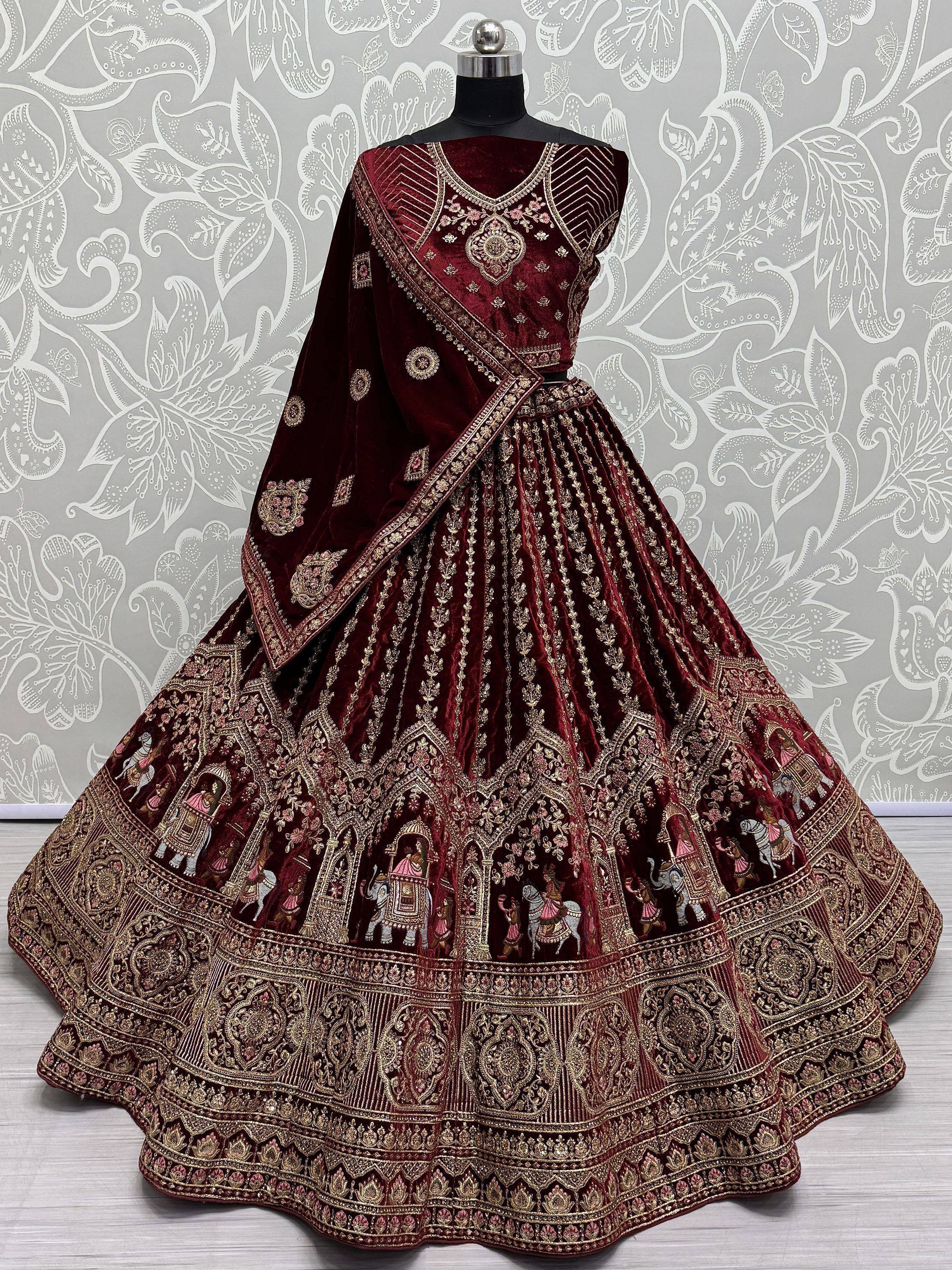 Maroon velvet lehenga choli with gold embroidery and royal motifs, perfect for Indian weddings and festive occasions.