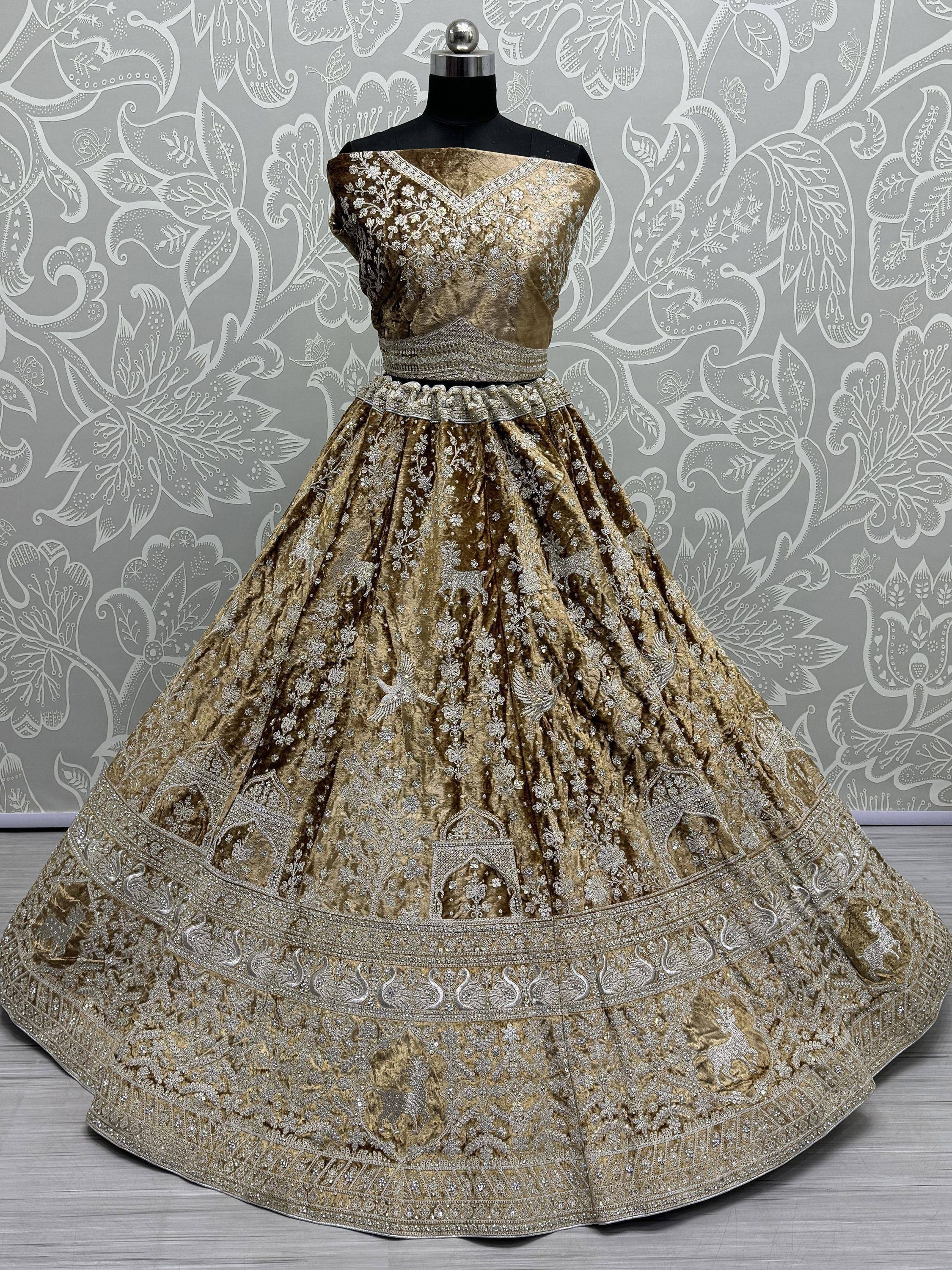 Gold velvet designer lehenga choli with silver embroidery, perfect for Indian weddings and festive occasions.