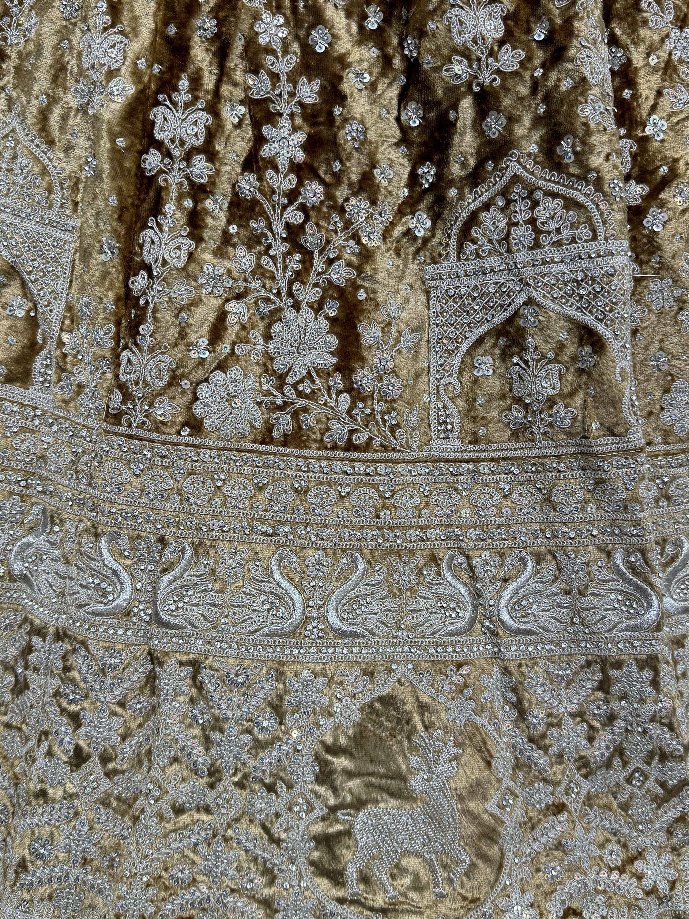Luxury Indian ethnic wear with silver embroidery, sequins, and swan motifs on velvet fabric.
