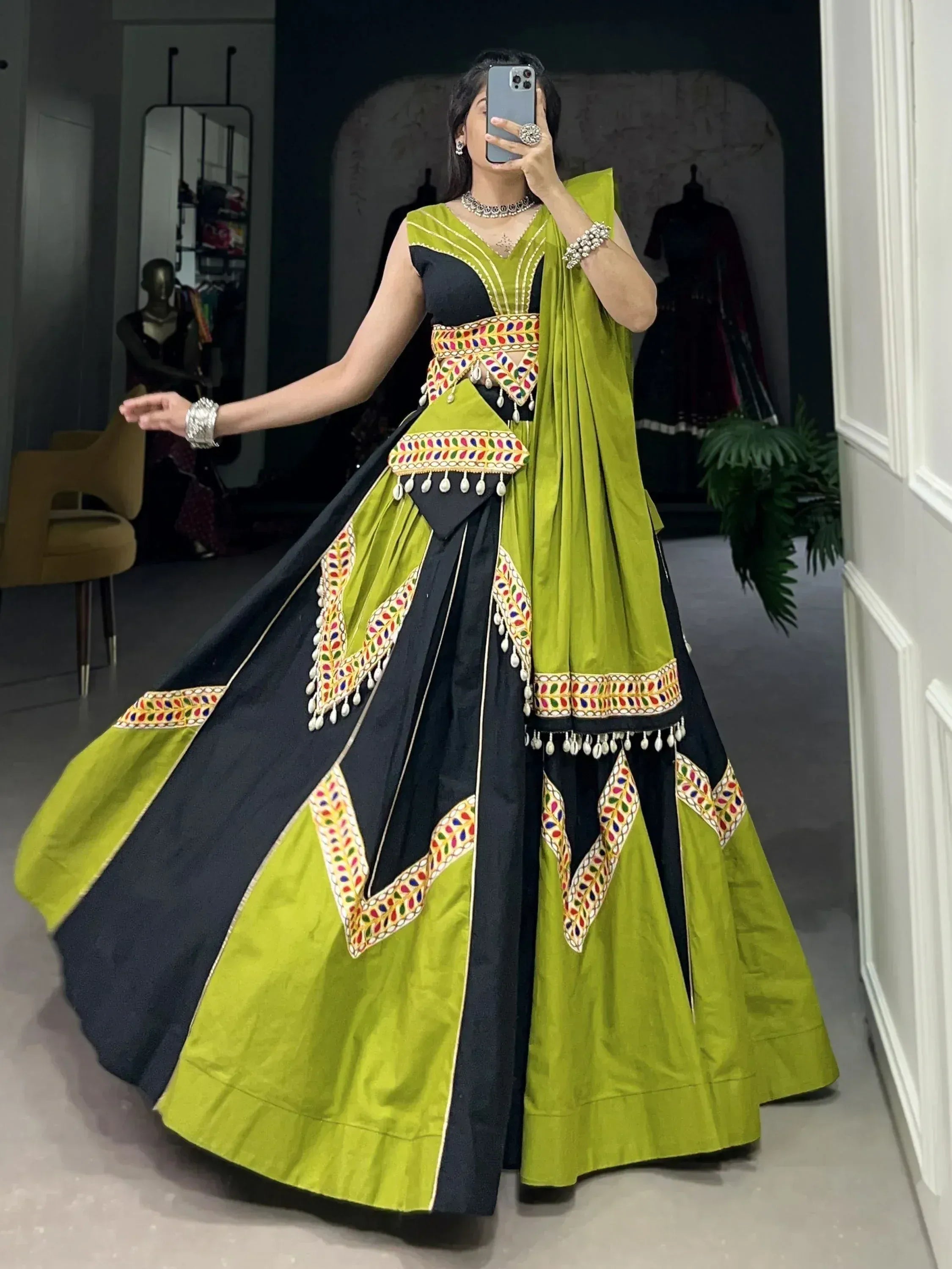 Green and black designer lehenga choli with mirror work and tassels, perfect for Indian ethnic wear