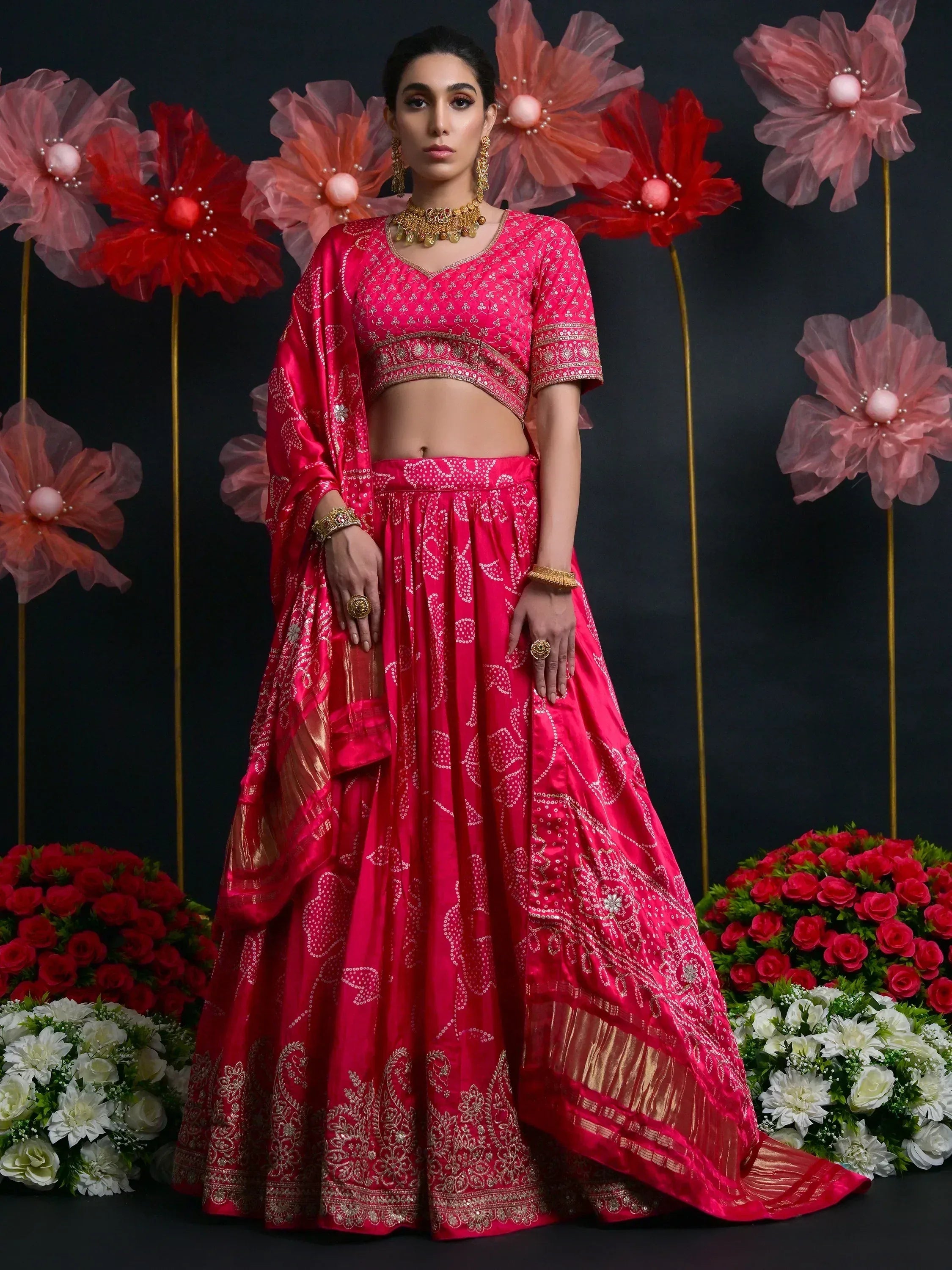 Pink embroidered lehenga choli with gold detailing, perfect for Indian weddings and festive occasions.