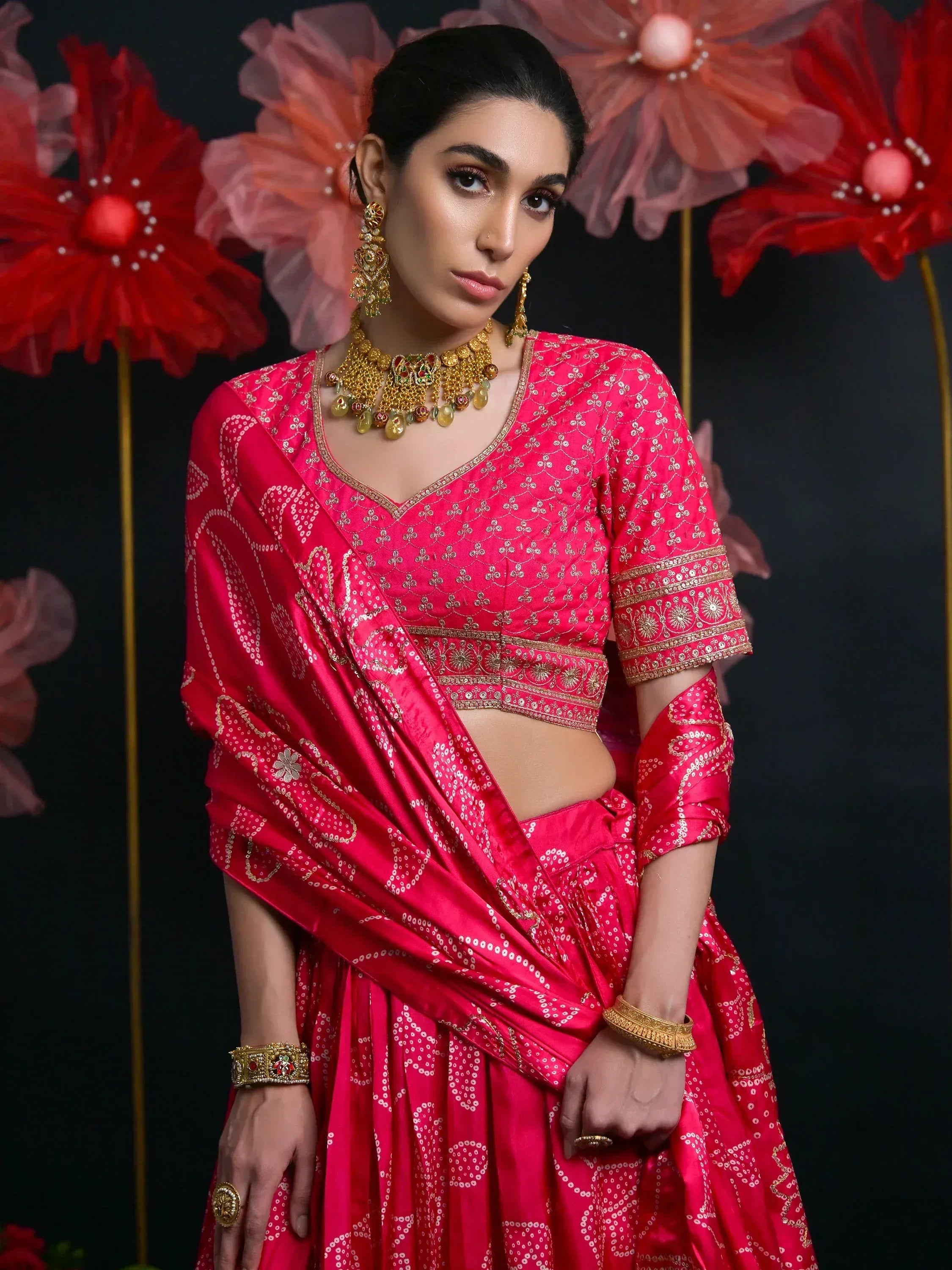 Pink embroidered lehenga choli with gold jewelry, perfect for Indian ethnic wear occasions