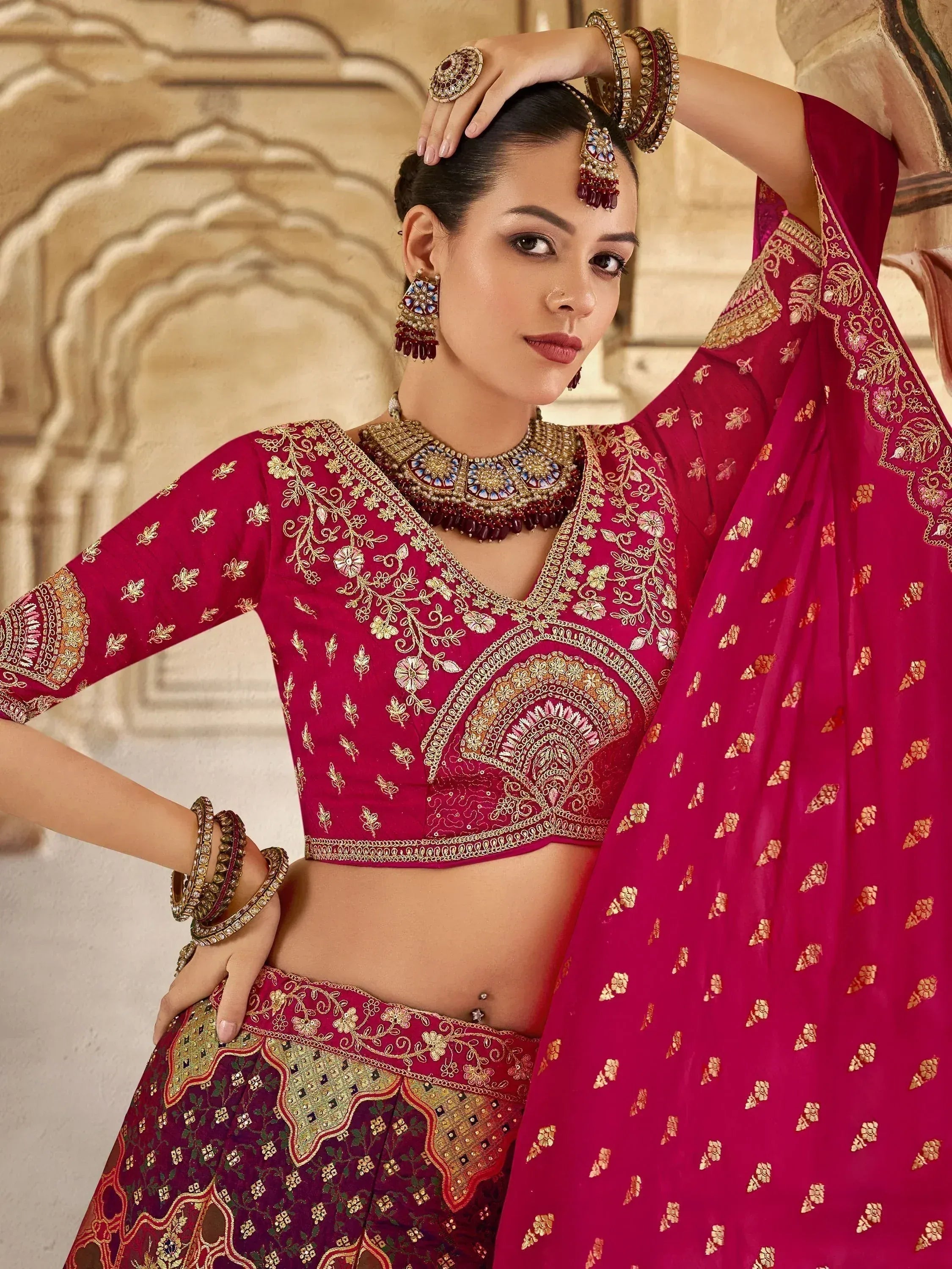 Elegant maroon lehenga choli with gold embroidery, perfect for Indian weddings and festive occasions.