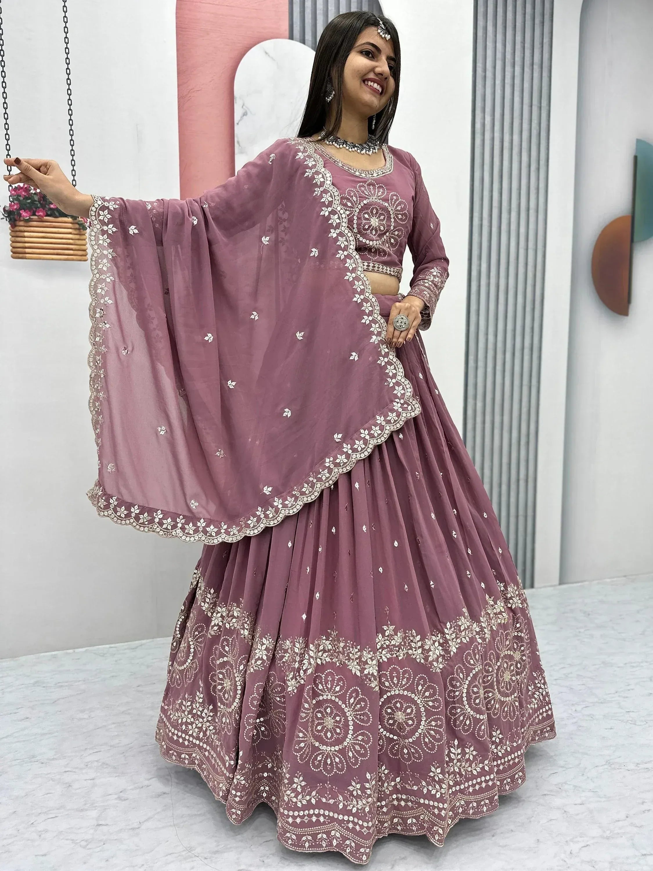 Dusty pink embroidered lehenga choli with floral motifs, perfect for Indian ethnic wear occasions.