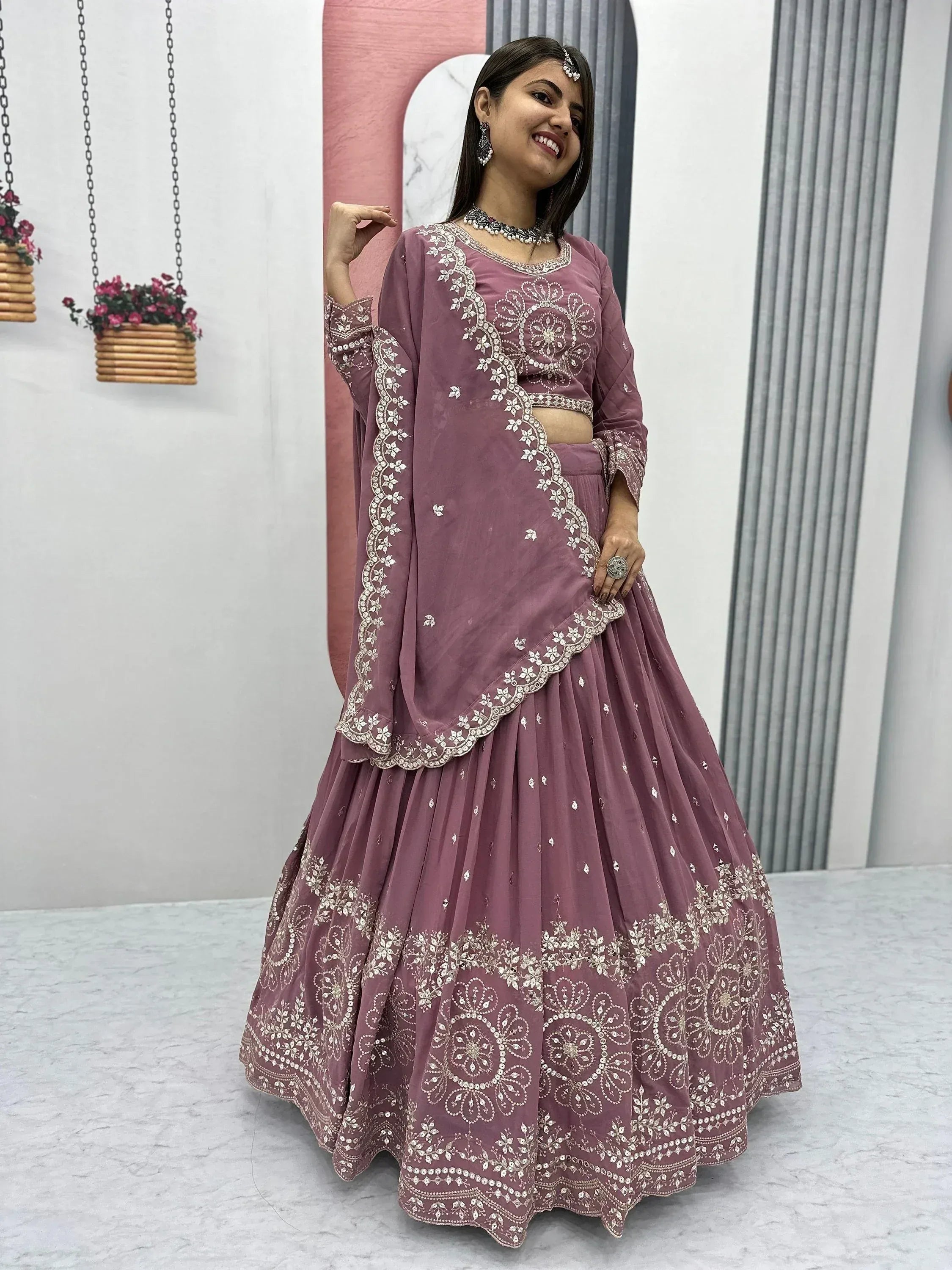 Dusty rose designer lehenga choli with intricate white embroidery, perfect for Indian ethnic wear occasions.