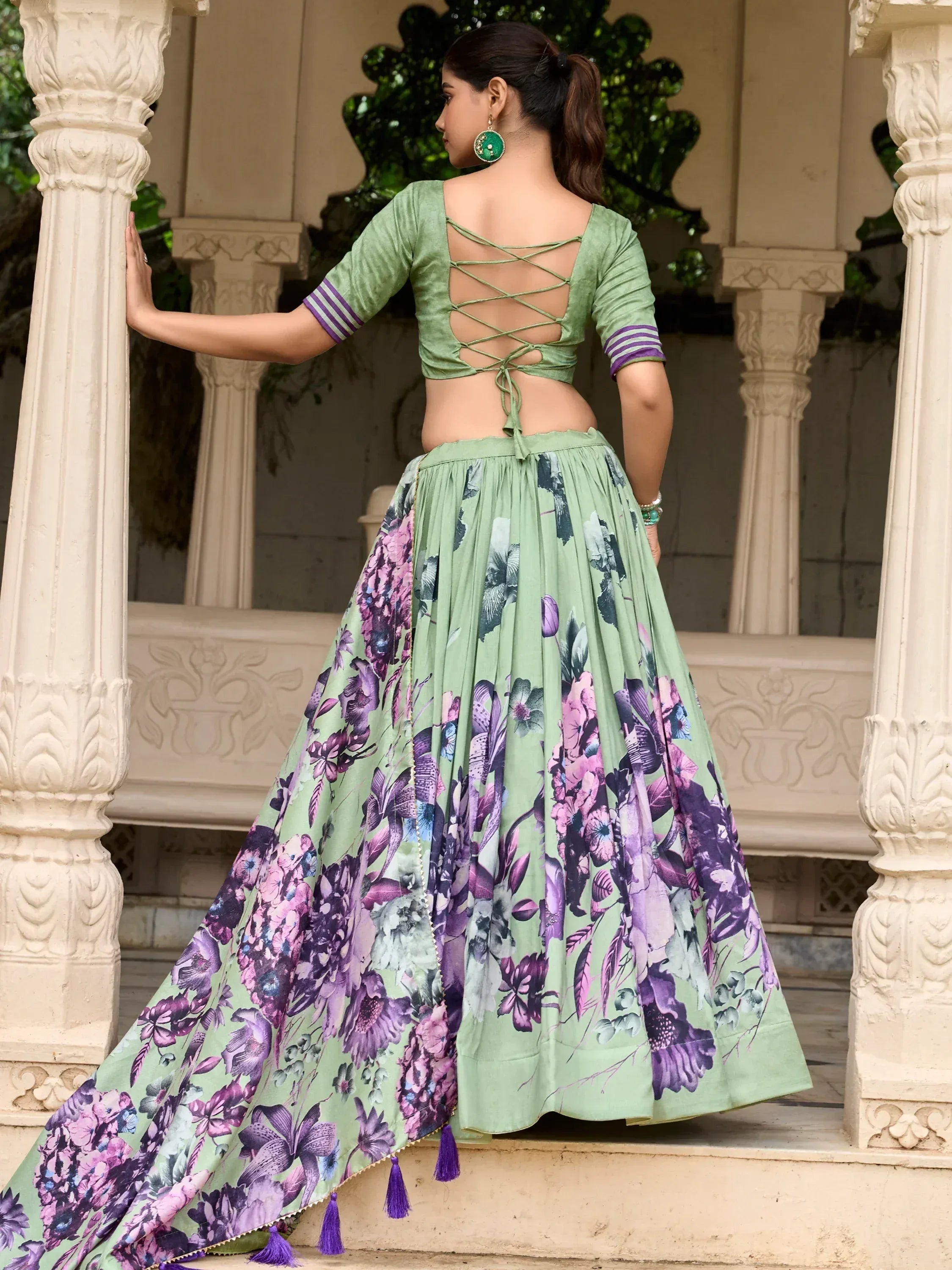 Green floral lehenga choli with crisscross back blouse, perfect for Indian ethnic wear occasions.