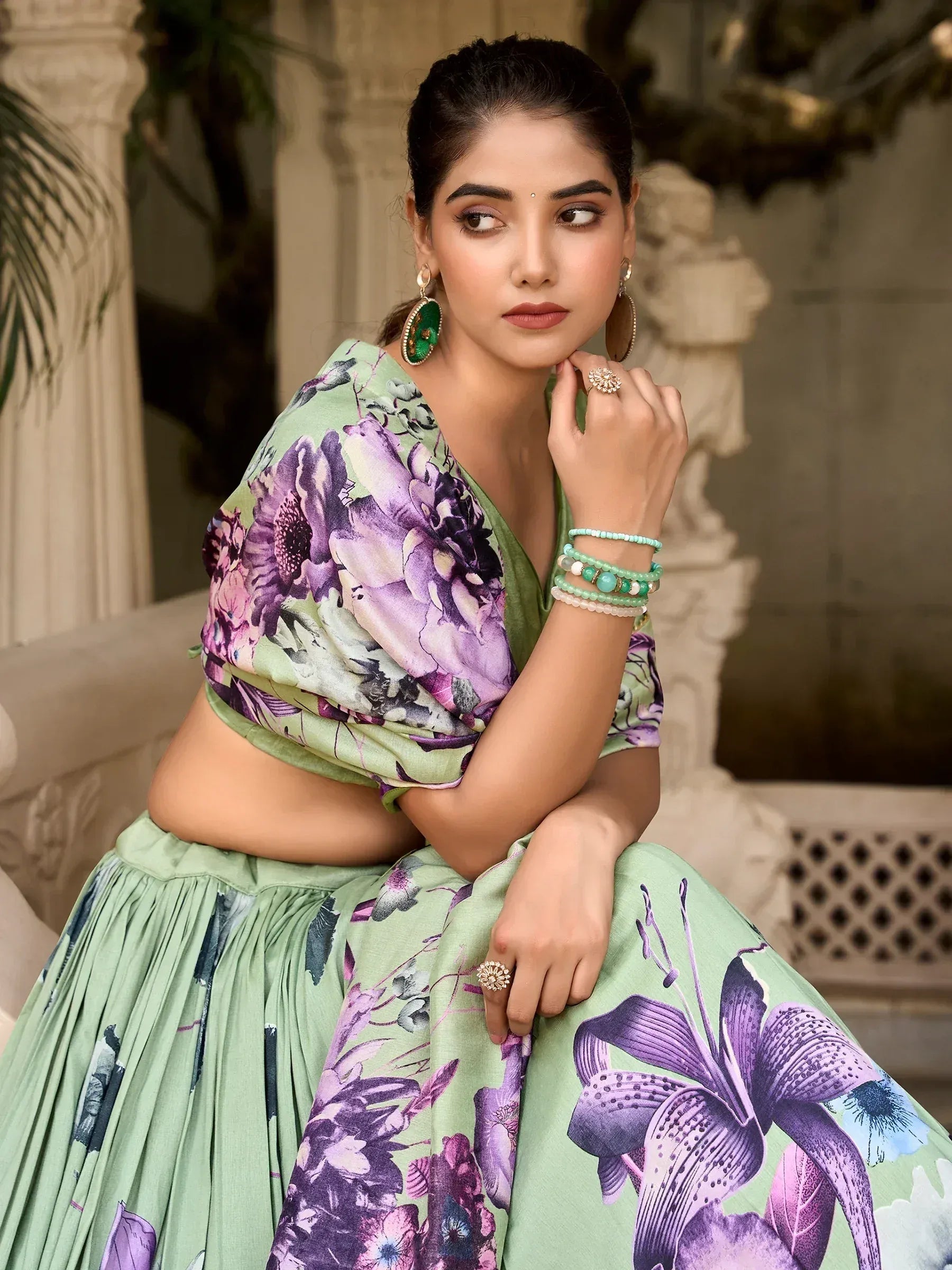 Green floral lehenga choli with purple blooms, perfect for Indian ethnic wear and festive occasions.