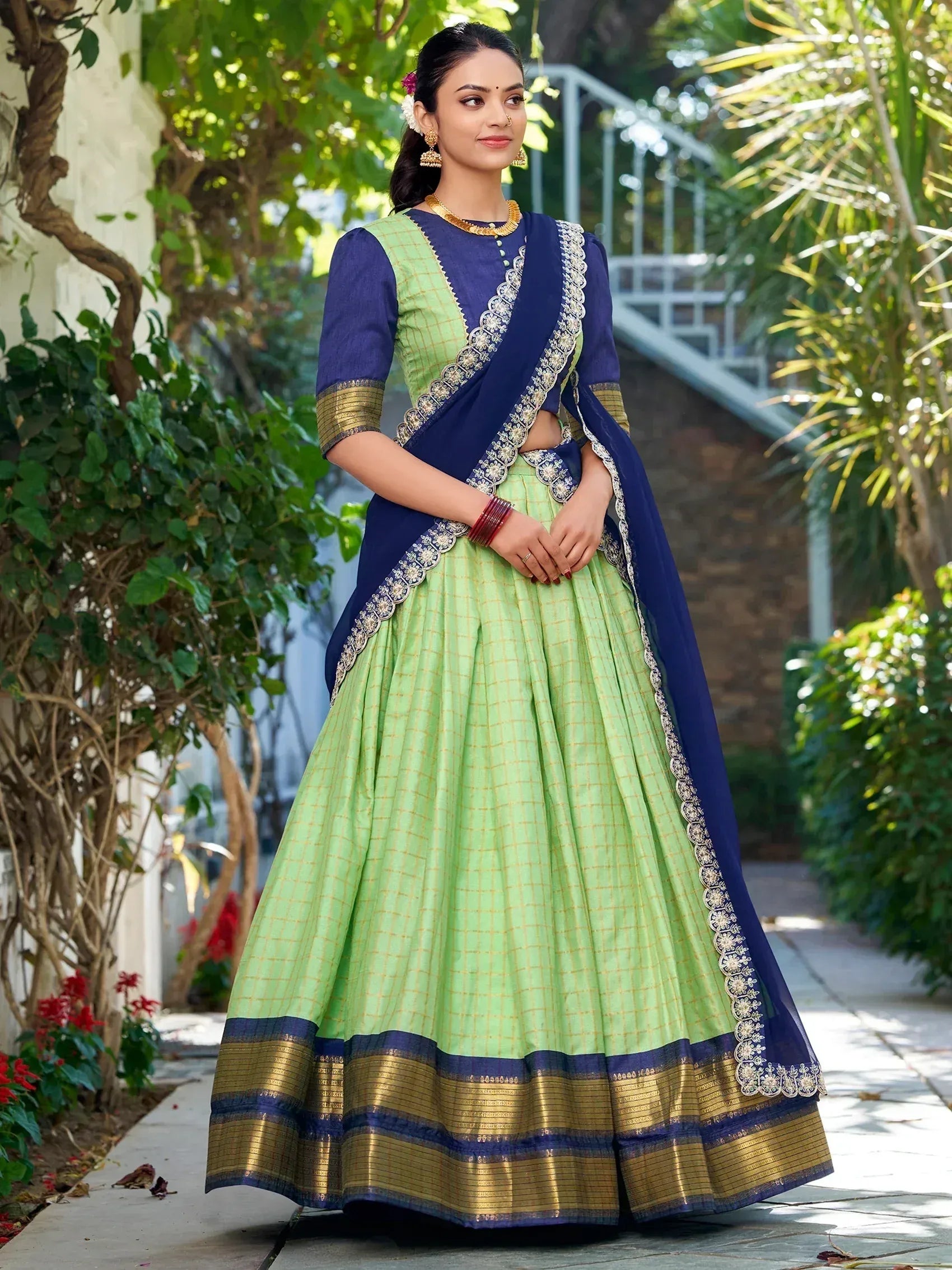 Green and blue designer lehenga choli with gold border and floral embroidery