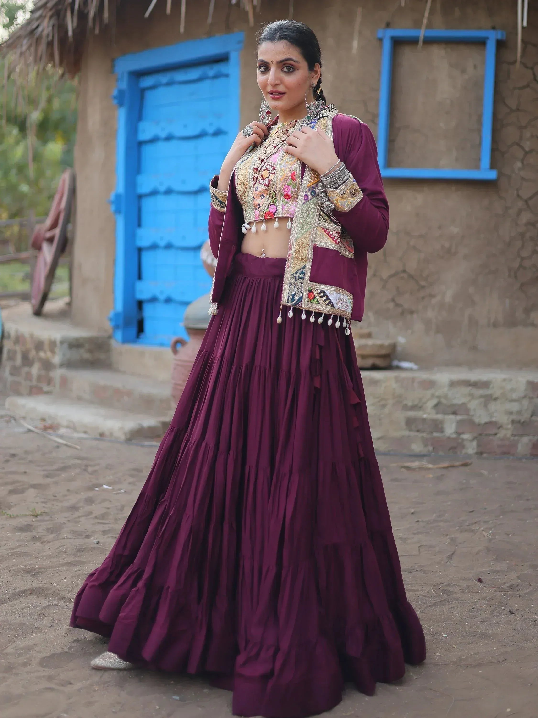Woman in maroon ethnic lehenga choli with embroidered jacket, traditional Indian wear