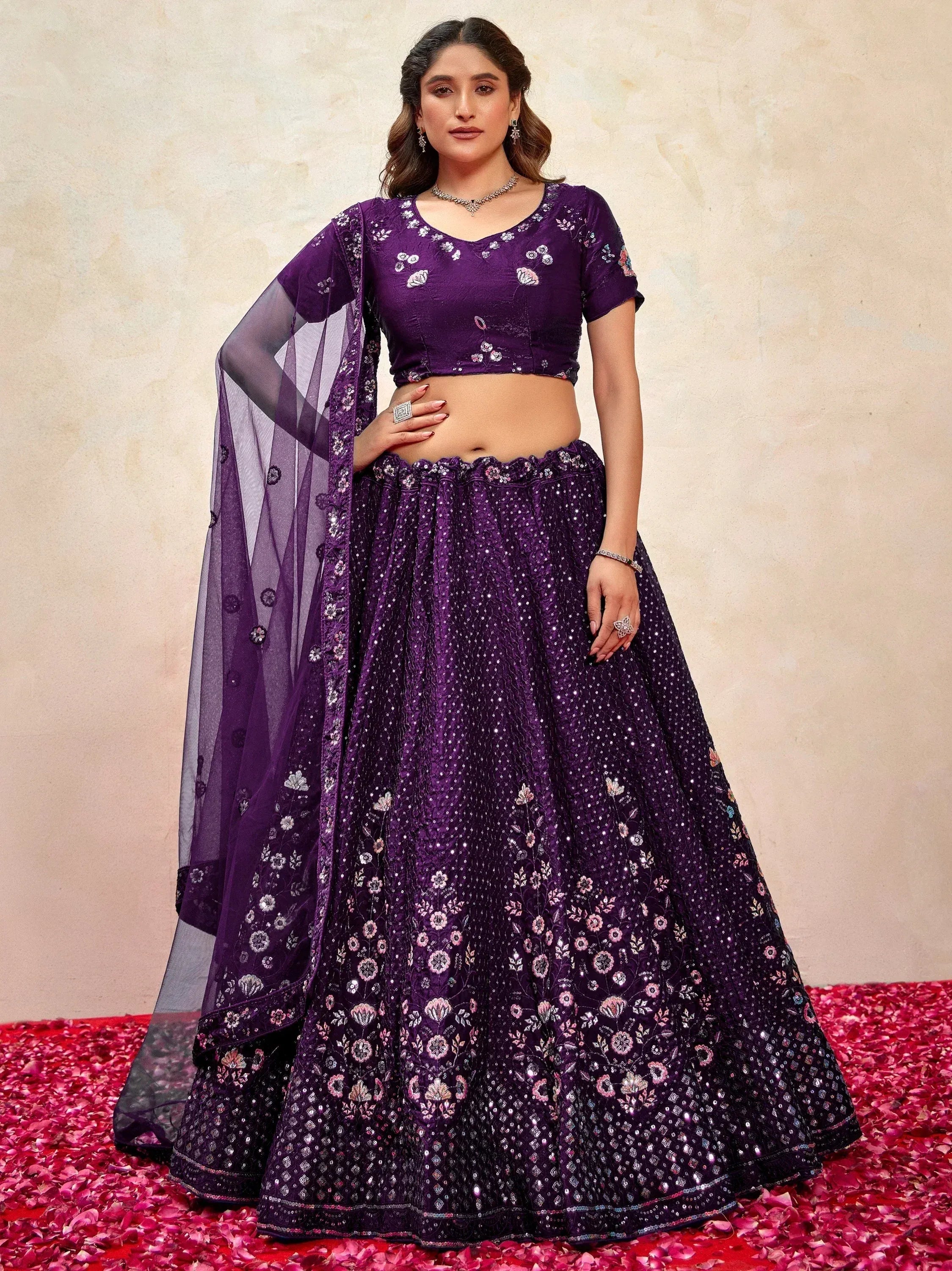 Purple floral embroidered lehenga choli with sheer dupatta, perfect for Indian weddings and festive occasions.