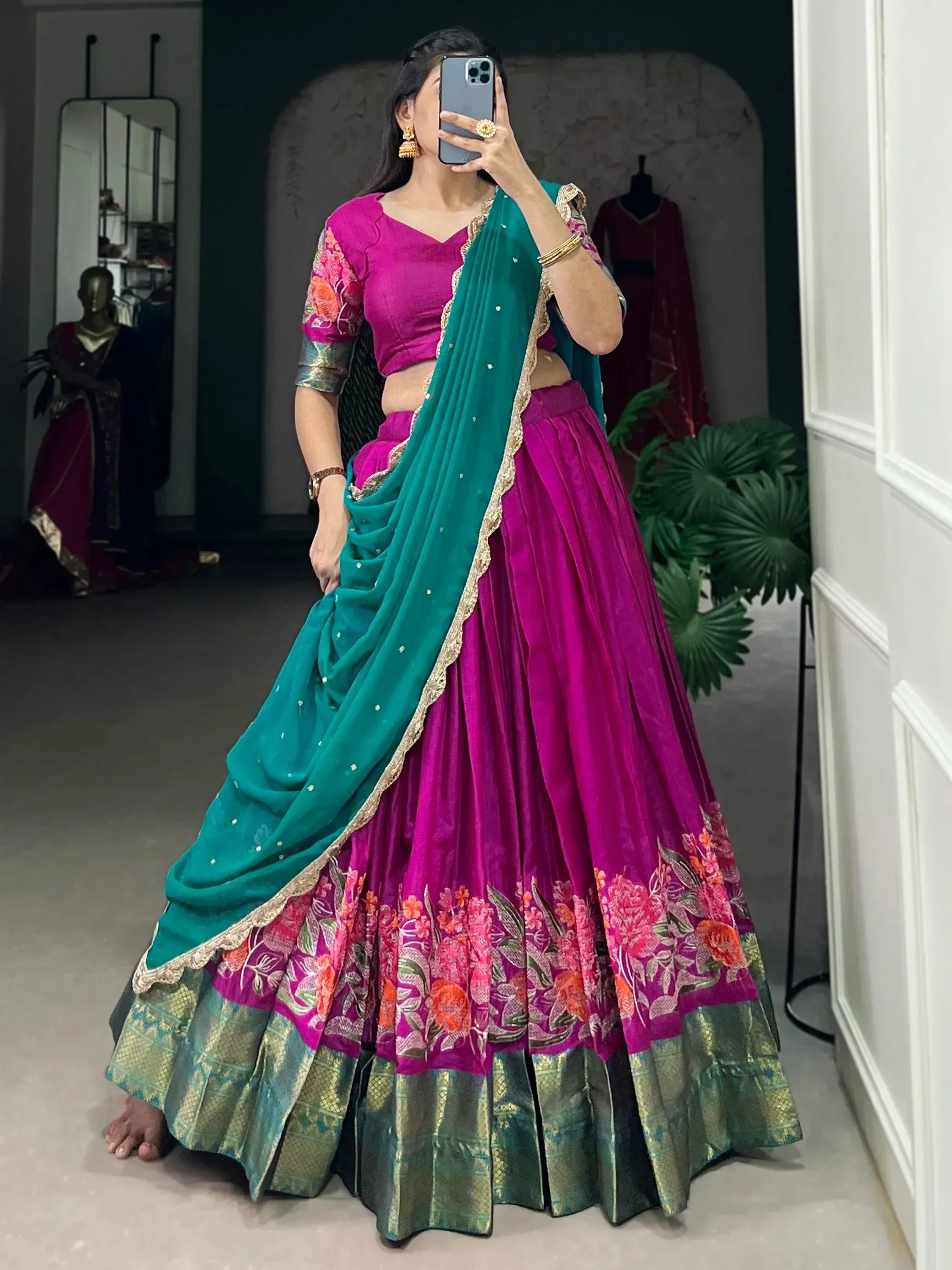Vibrant magenta lehenga choli with floral embroidery and teal dupatta, perfect for Indian ethnic occasions.
