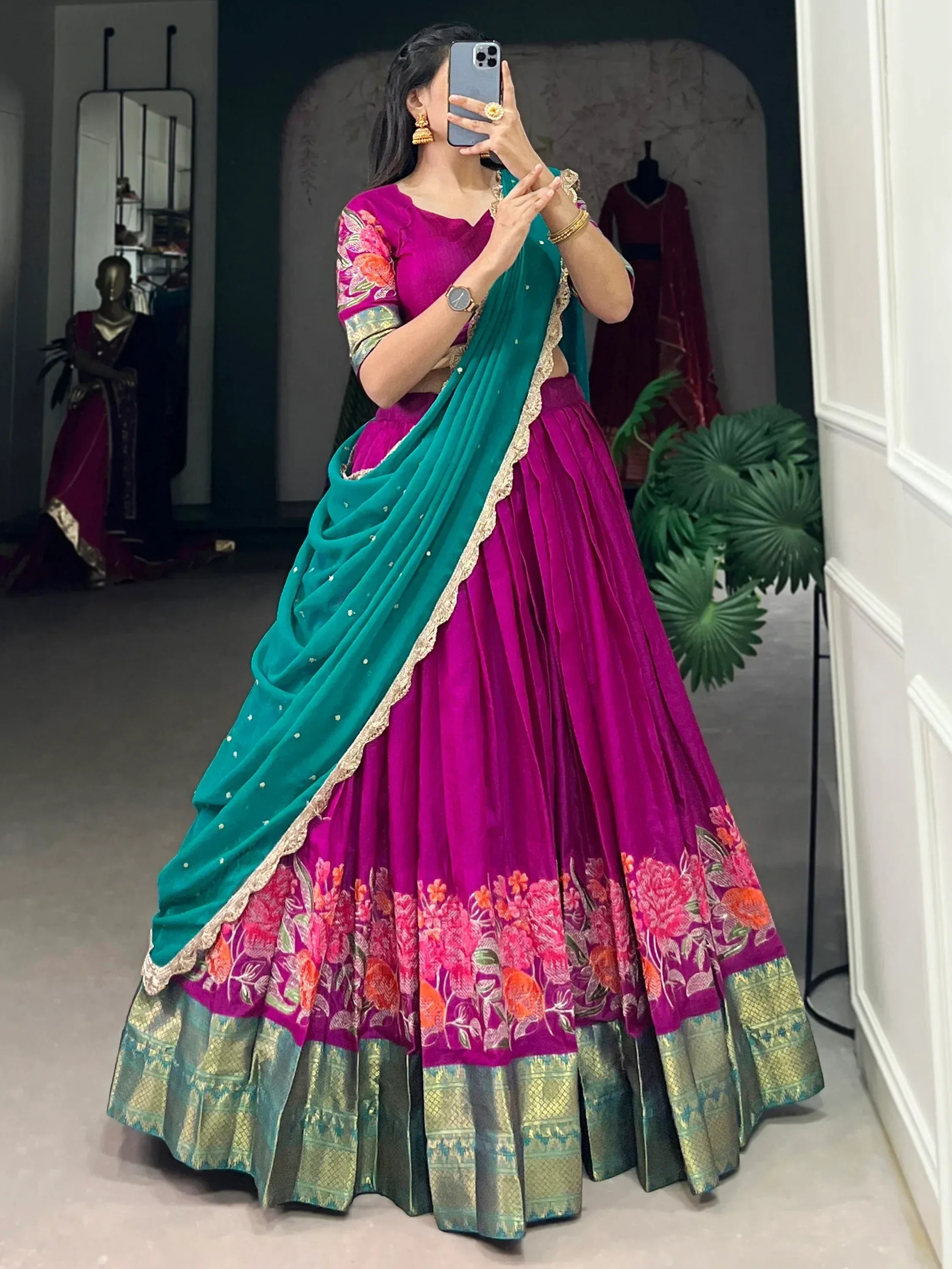 Vibrant magenta lehenga choli with floral embroidery and teal dupatta, perfect for Indian ethnic wear occasions.