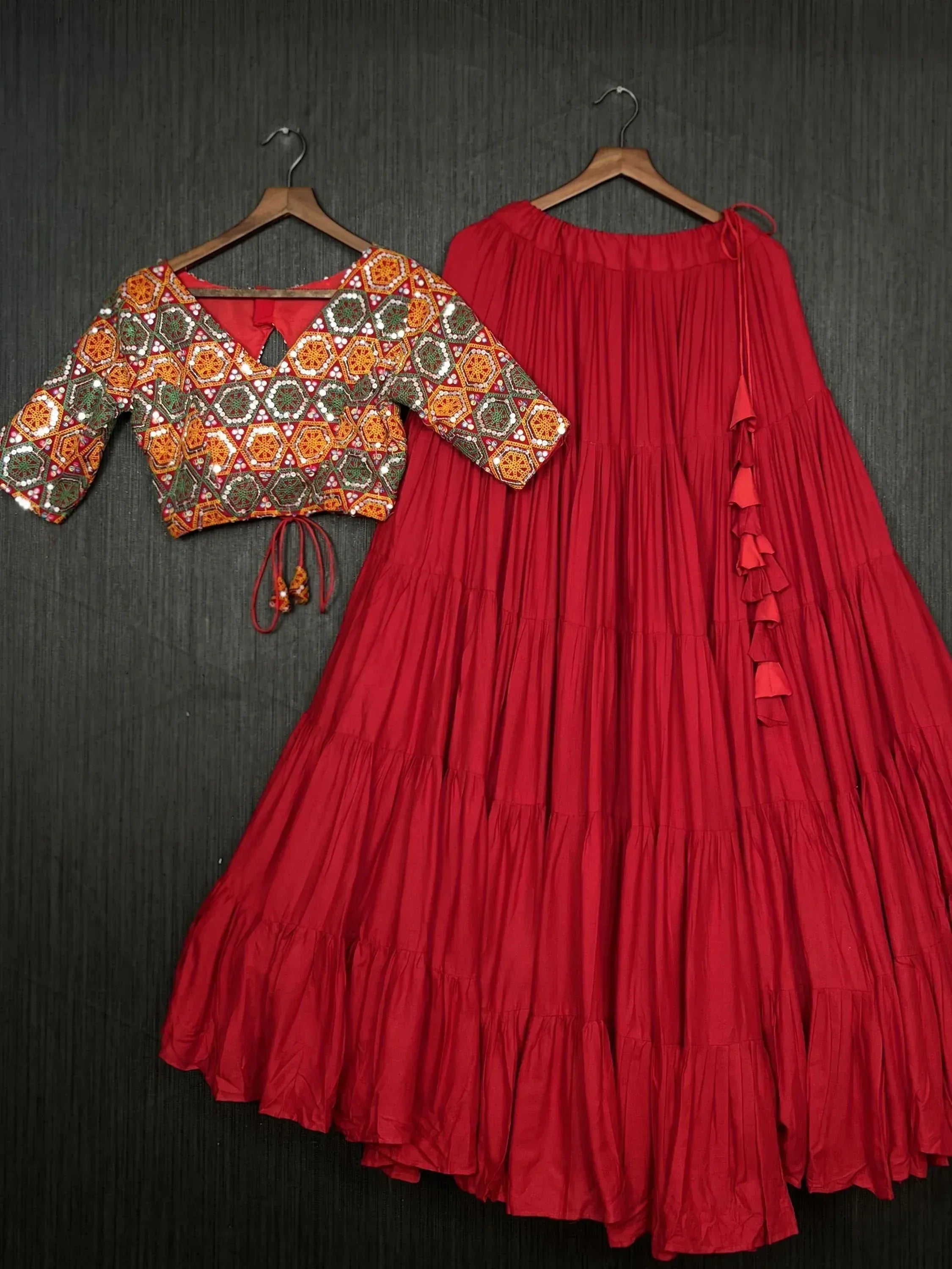 Red ethnic lehenga with mirror work blouse, tiered skirt, ruffle details, perfect for Indian festive wear