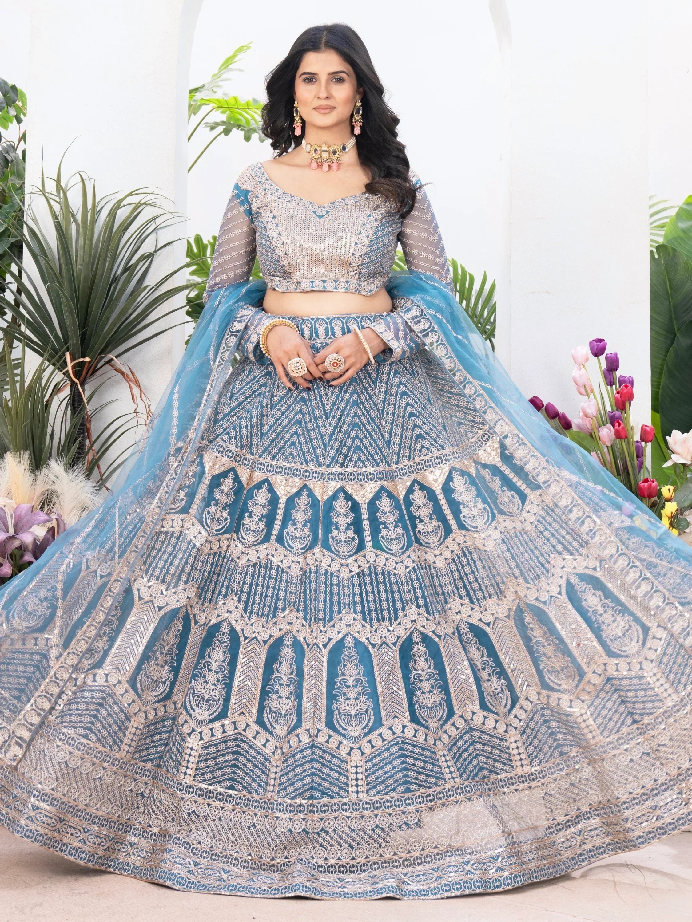 Blue and gold embroidered lehenga choli with sheer sleeves, perfect for Indian weddings and festive occasions