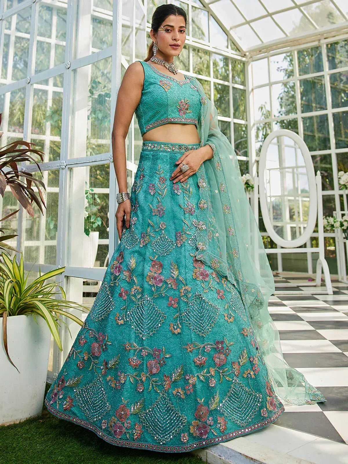 Teal floral embroidered lehenga choli with sheer dupatta, perfect for Indian weddings and festive occasions
