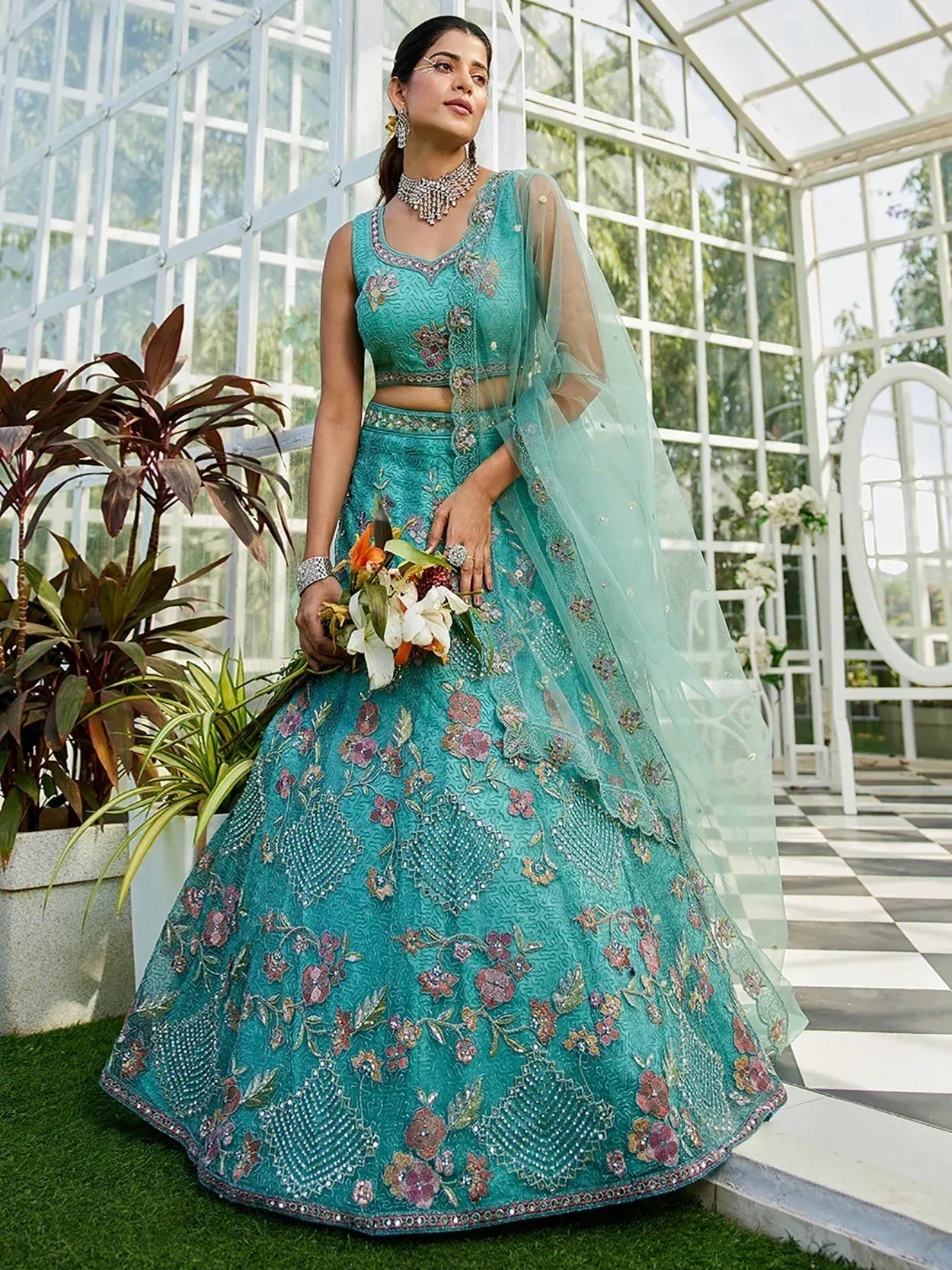 Teal embroidered lehenga choli with floral motifs, sheer dupatta, perfect for Indian weddings or festive occasions