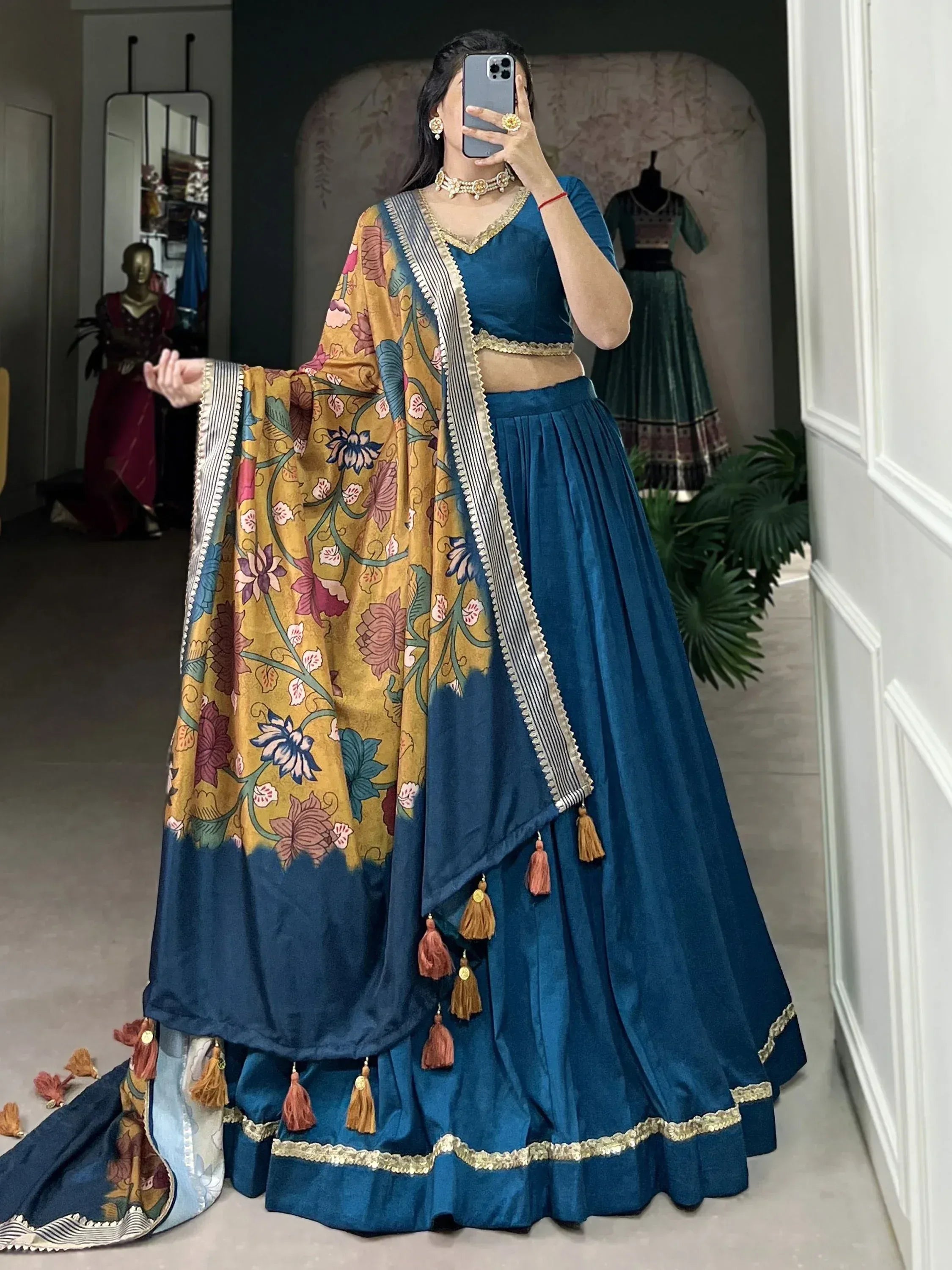 Blue velvet lehenga choli with floral dupatta, tassels, and gold trim for Indian ethnic wear