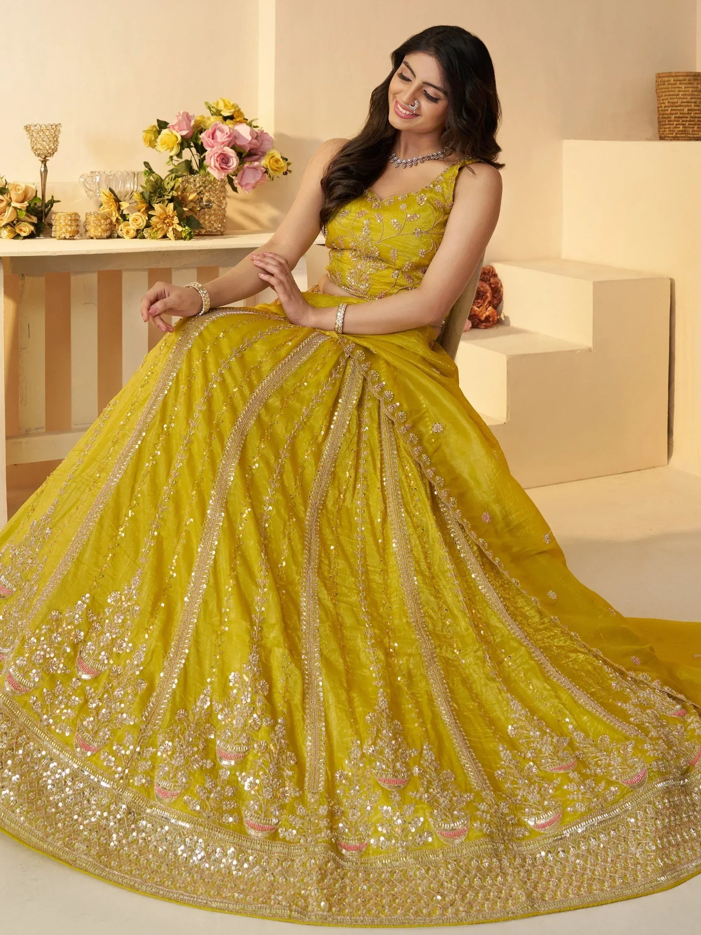 Yellow designer lehenga choli with heavy embroidery and sequins for weddings and festivals